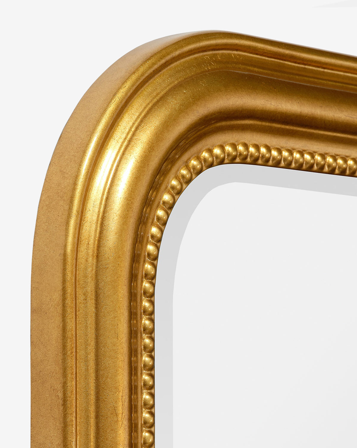 Close-up of the Vienna Mirrors top left corner, showing its gold-leaf finish, beaded details, and smooth reflective surface bordered by a classic molded frame, by McGee & Co.