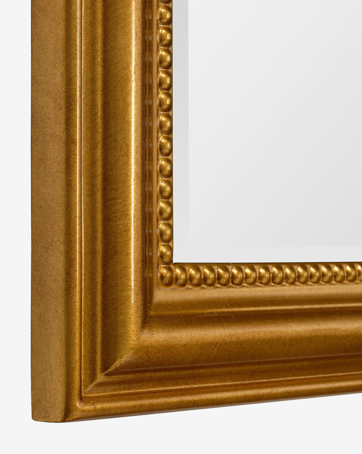 Close-up of the Vienna Mirror’s corner, showcasing its gold-leaf finish, beaded detailing, and timeless molded border framing a white background, by McGee & Co.