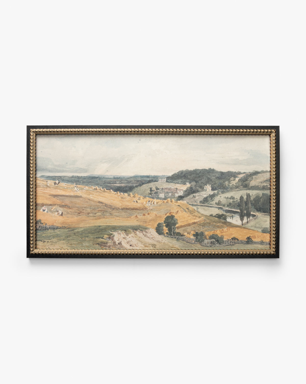 The framed artwork View of St Catherines Hill Near Guildford by Charles Claude Pyne shows rolling hills, golden fields, scattered trees, and distant buildings beneath a partly cloudy sky, by McGee & Co.