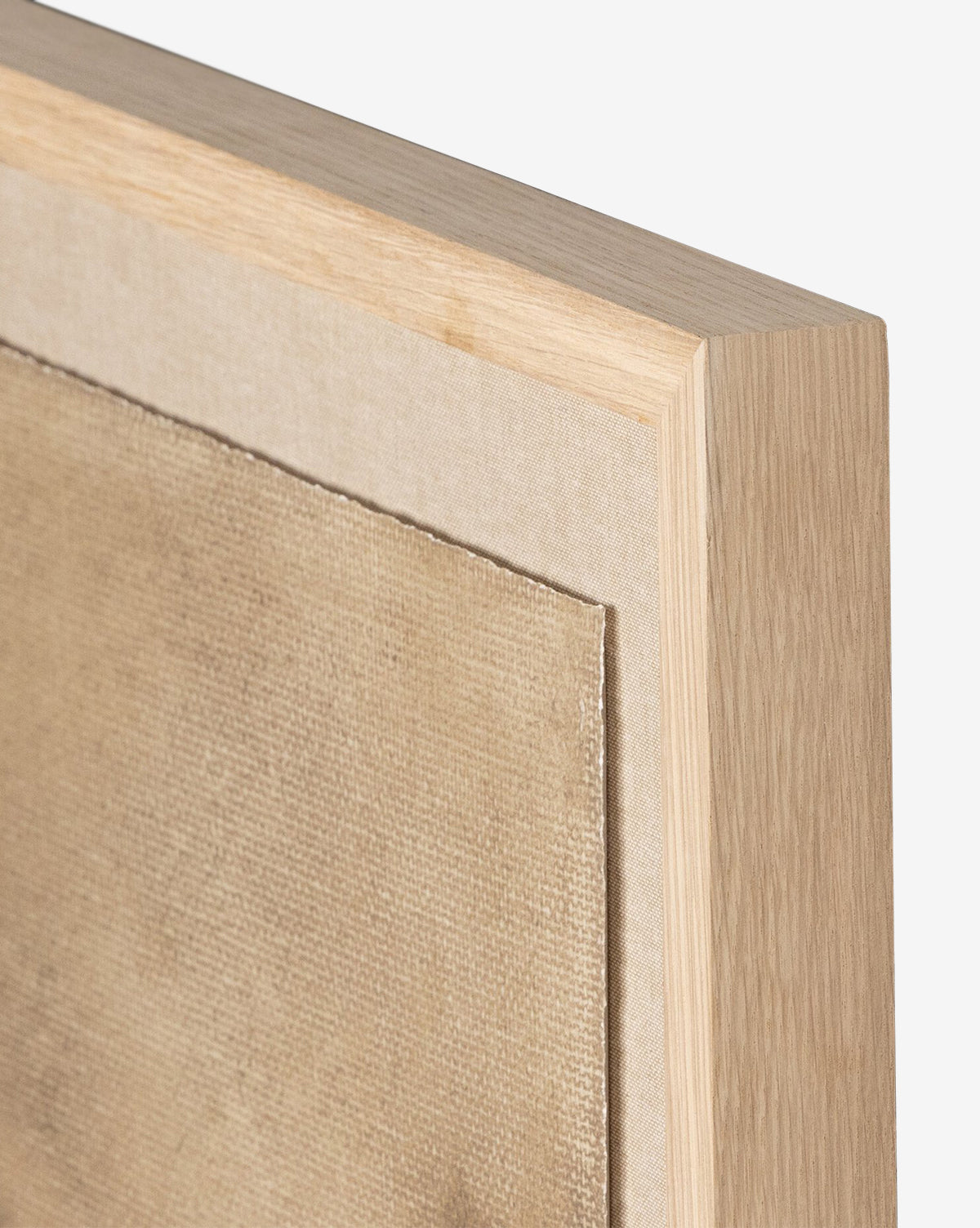 Close-up of the corner of a museum-quality wooden frame holding Viewpoint I by Aileen Fitzgerald, featuring a beige textured canvas against a plain white background.