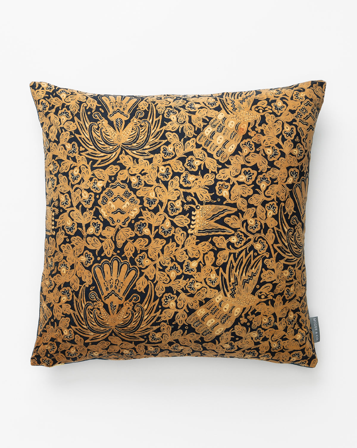 The Vintage Gold Patterned Pillow Cover No. 4 features a black background with intricate golden floral and bird batik designs and a small gray tag on one side for an elegant, heirloom-quality look, by McGee & Co.