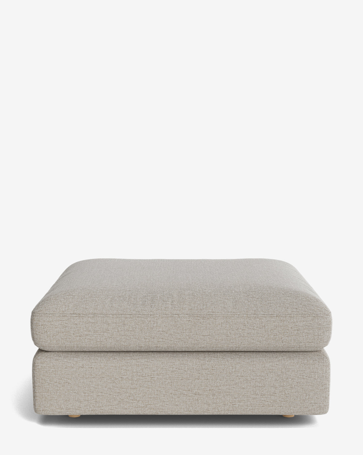 The Vivienne Modular Ottoman by Makerspalm is a modern, rectangular piece in light gray high-quality fabric with a soft, cushioned top and low wooden legs, shown against a plain white background by McGee & Co.