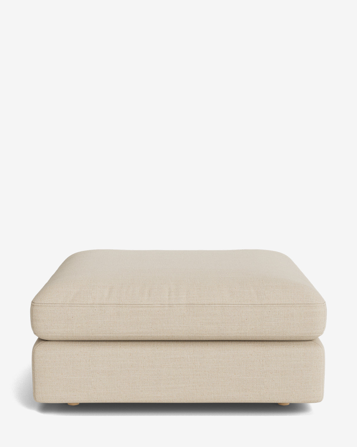 The Vivienne Modular Ottoman is a beige, rectangular piece with a simple modern design, upholstered in textured fabric and supported by small, unobtrusive feet, shown against a plain white background by McGee & Co.