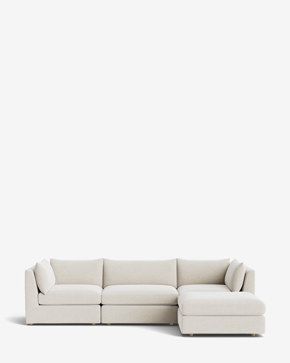 The Vivienne Modular Sofa with Ottoman features a modern, light beige design with three seat cushions on the left, a chaise lounge on the right, and two matching throw pillows at each end, set against a plain white background by McGee & Co.