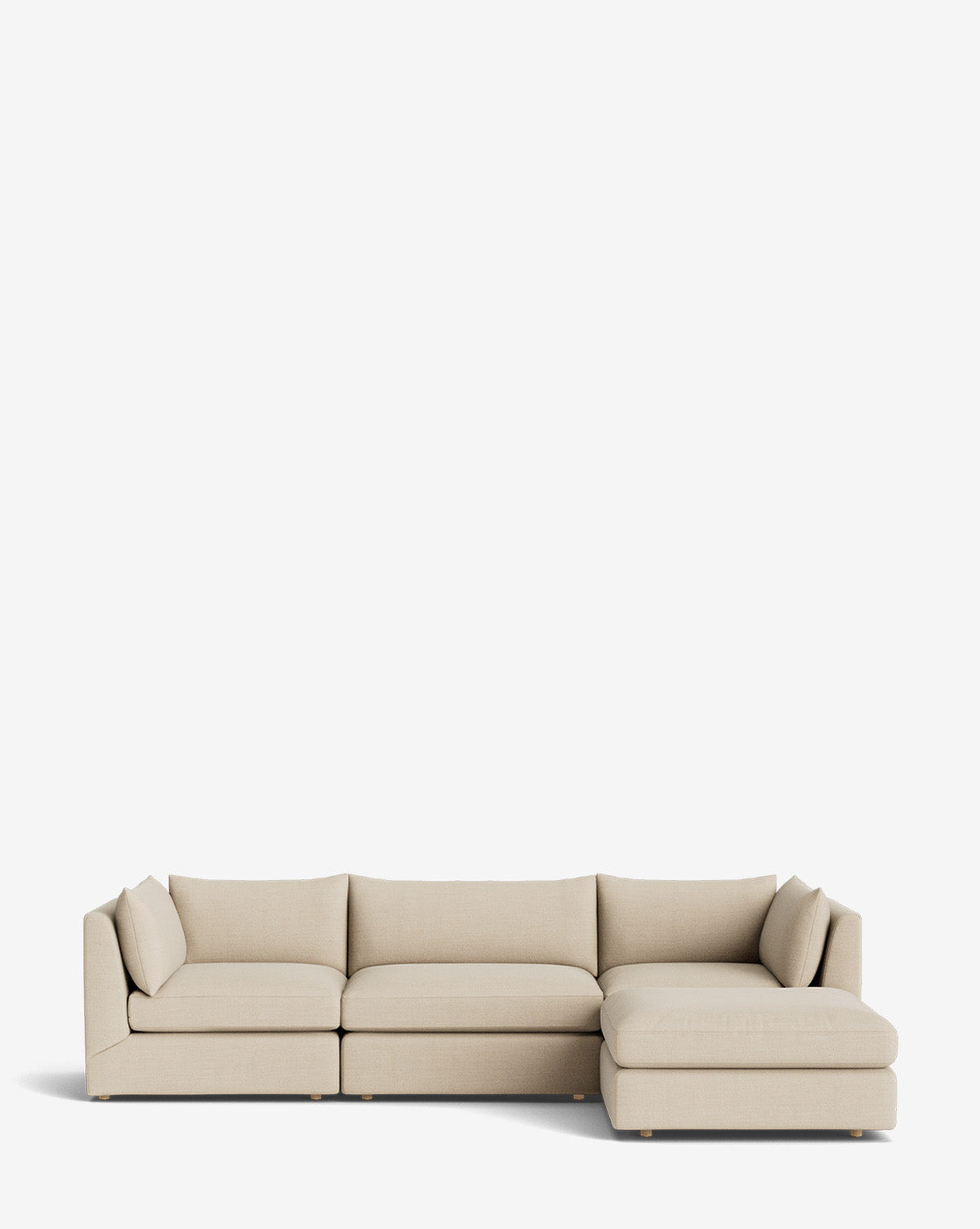 The Vivienne Modular Sofa with Ottoman is a handmade beige L-shaped sofa featuring three left seat cushions and a right-side chaise lounge, shown against a plain white background, by McGee & Co.