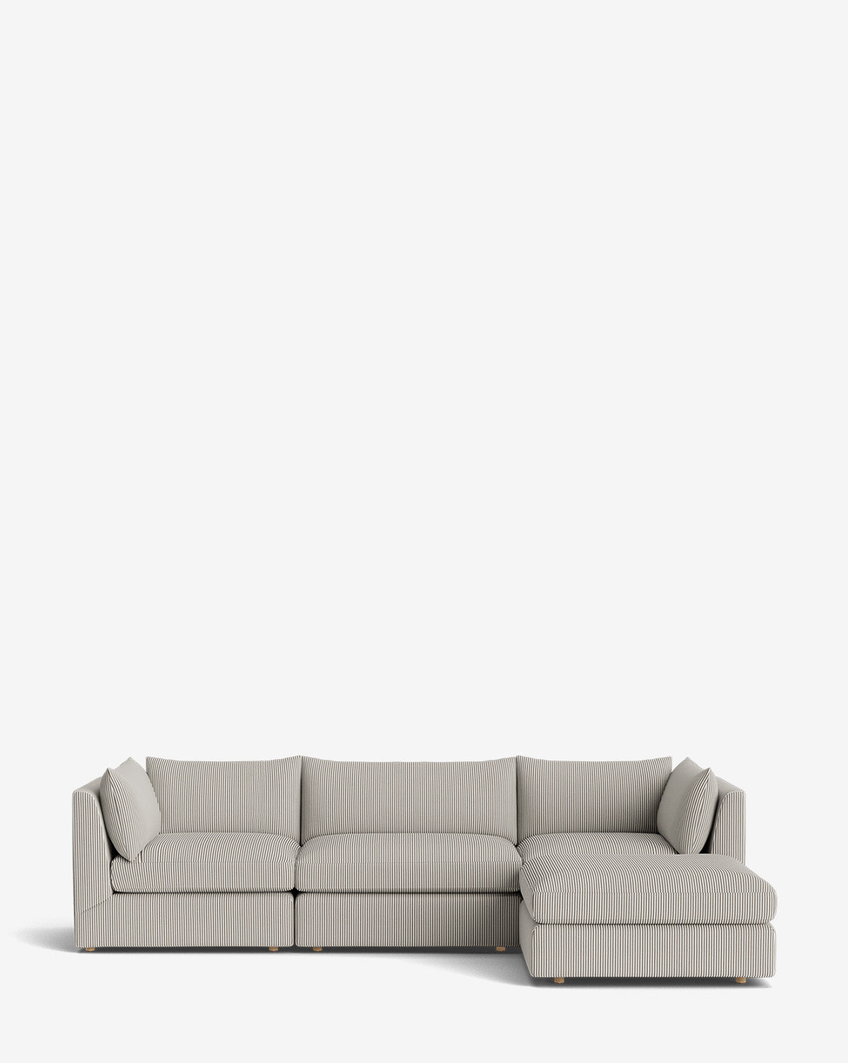 The Vivienne Modular Sofa with Ottoman is a modern light gray piece with vertical textured lines, a right-side chaise lounge, and two matching cushions, displayed against a plain white background by McGee & Co.