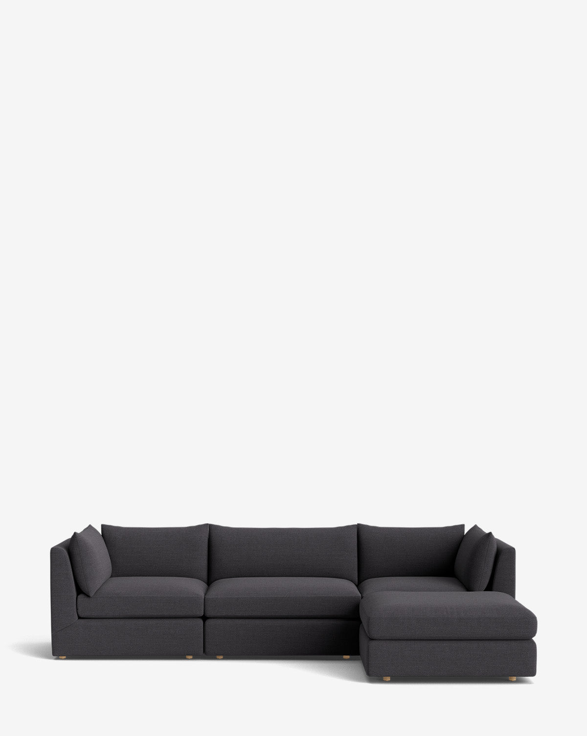 The Vivienne Modular Sofa with Ottoman features a modern dark gray design, three seat cushions, and a right-side chaise lounge, shown against a plain white background, by McGee & Co.
