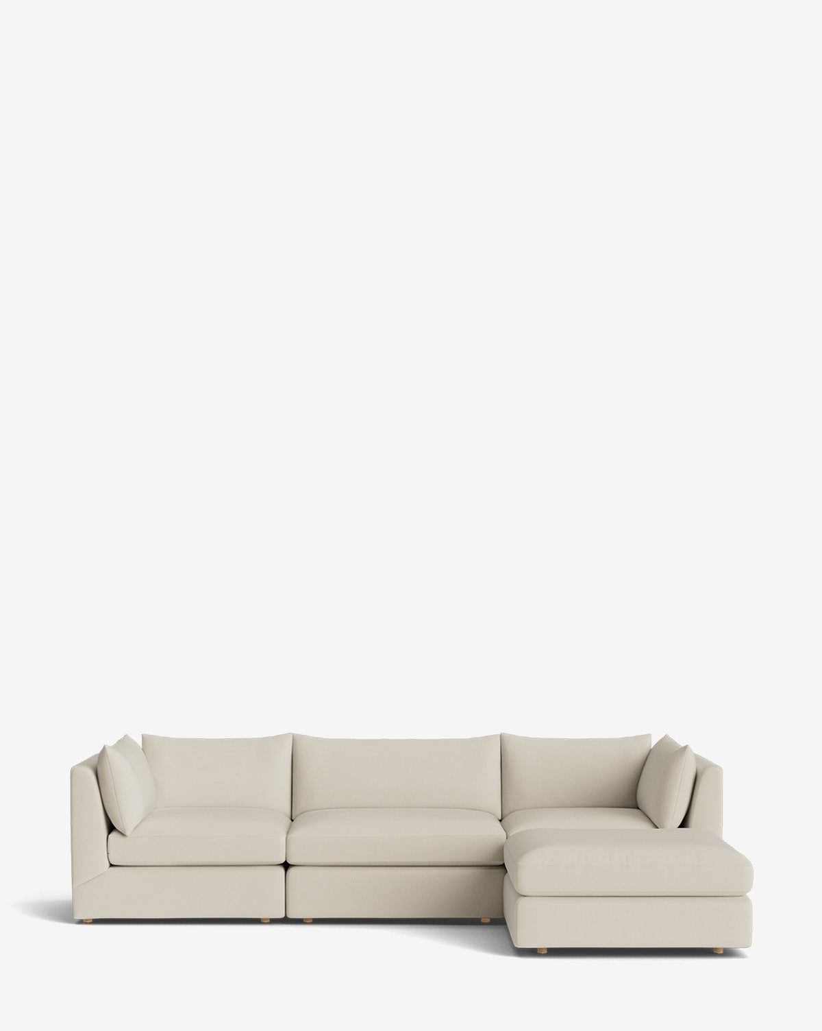 The Vivienne Modular Sofa with Ottoman is a modern, light beige three-seater with a right-facing chaise, clean lines, low backrests, and minimalist cushions, shown against a plain white background by McGee & Co.