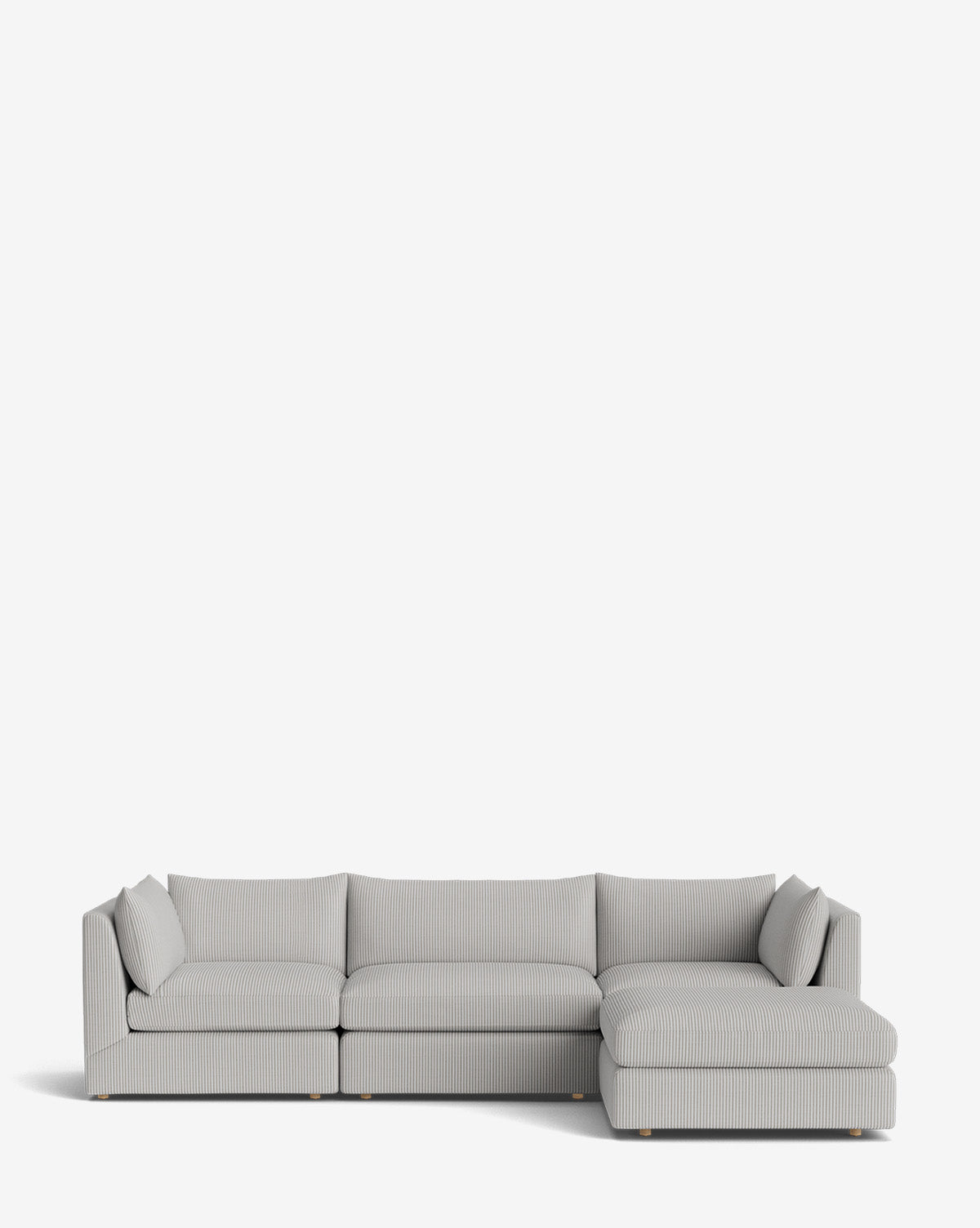 The Vivienne Modular Sofa with Ottoman is a modern handmade light gray piece featuring subtle vertical stripes, a low backrest, and a right-side chaise lounge, displayed against a plain white background by McGee & Co.