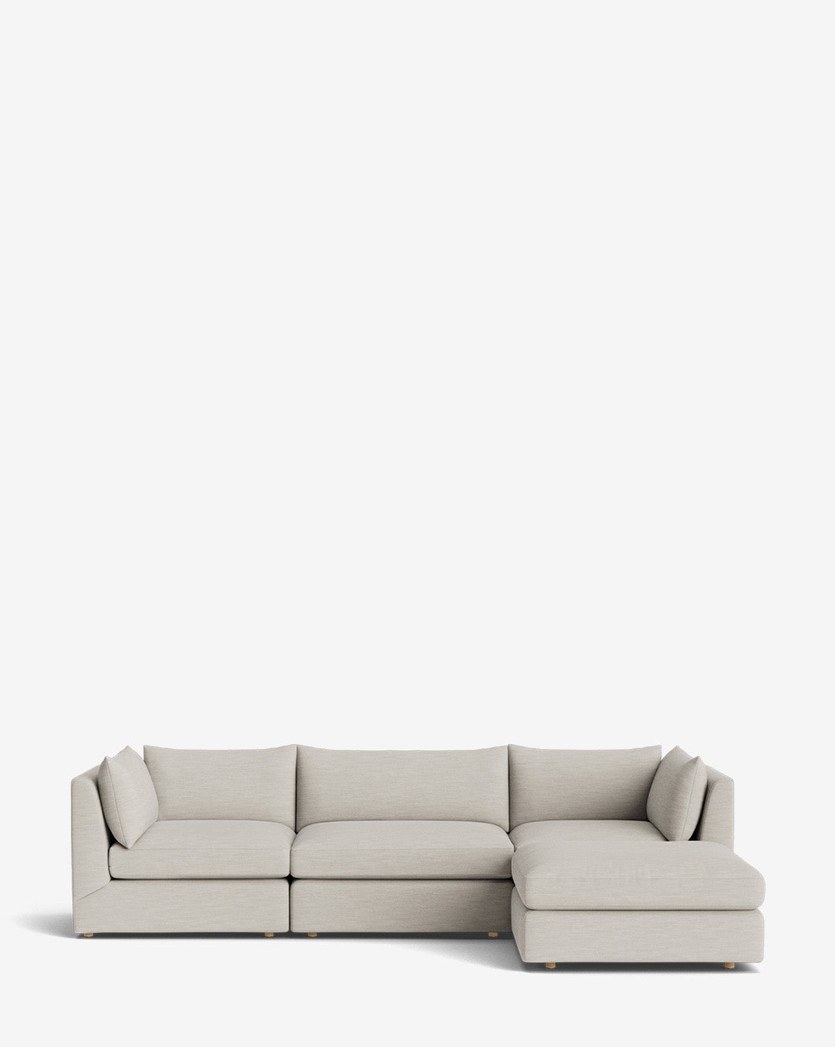 The Vivienne Modular Sofa with Ottoman features a modern design in light gray, clean lines, low-profile cushions, a right-facing chaise lounge, and an optional ottoman, shown on a plain white background by McGee & Co.