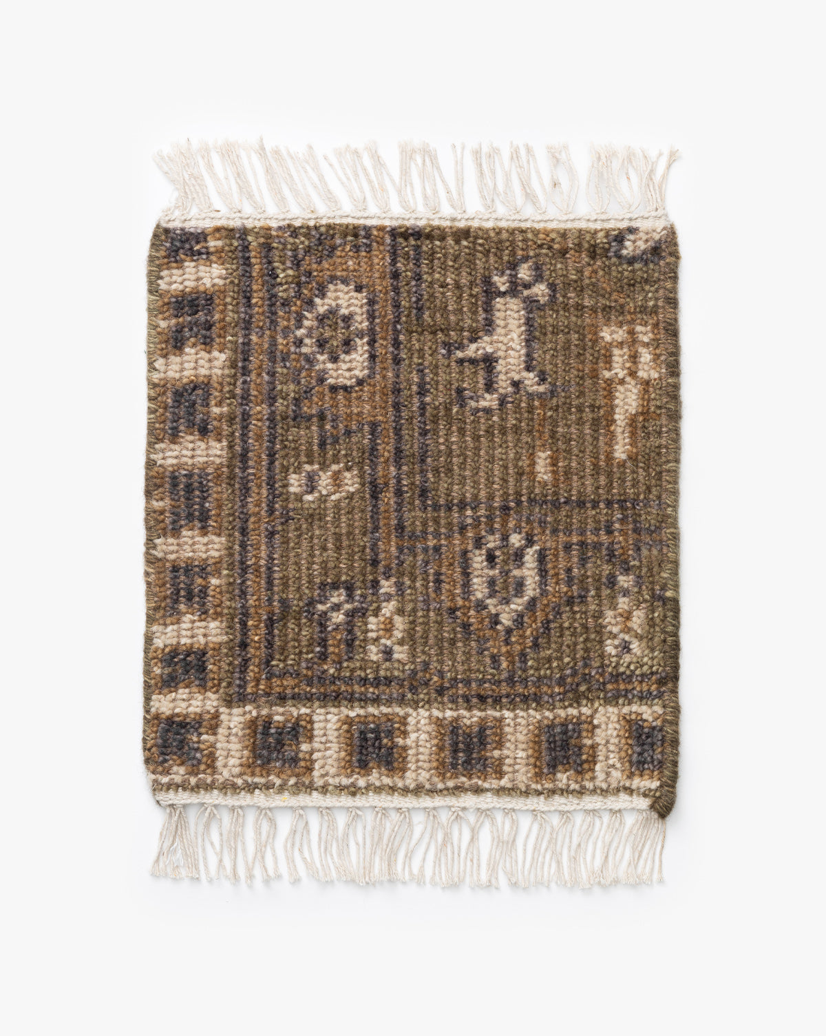 The Wayland Hand-Knotted Wool Rug Swatch is a small, rectangular piece featuring brown, beige, and blue geometric patterns, textured surface, fringed edges on two sides, and artisan abstract symmetrical designs by McGee & Co.