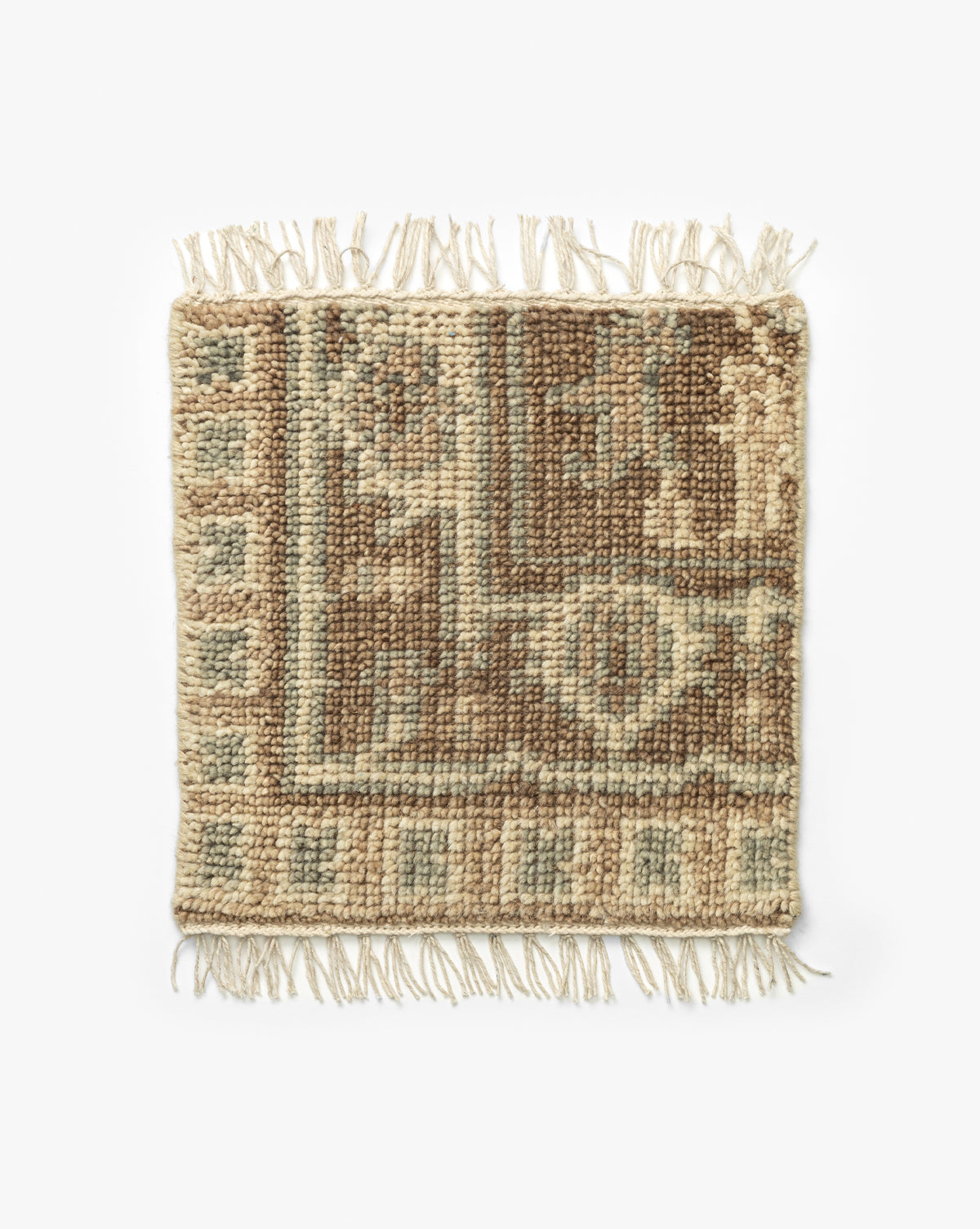Wayland Hand-Knotted Wool Rug Swatch: a small rectangular wool sample with beige, brown, and light blue geometric patterns and short fringe on both shorter edges, shown on a white background by McGee & Co.