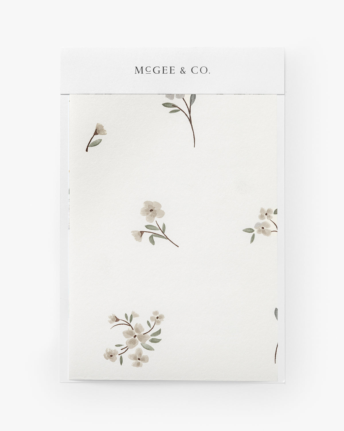 The Wembley Floral Wallpaper Swatch features delicate cream-colored flowers and green leaves on a white background, with a timeless design that adds an elegant touch to any room, by McGee & Co.