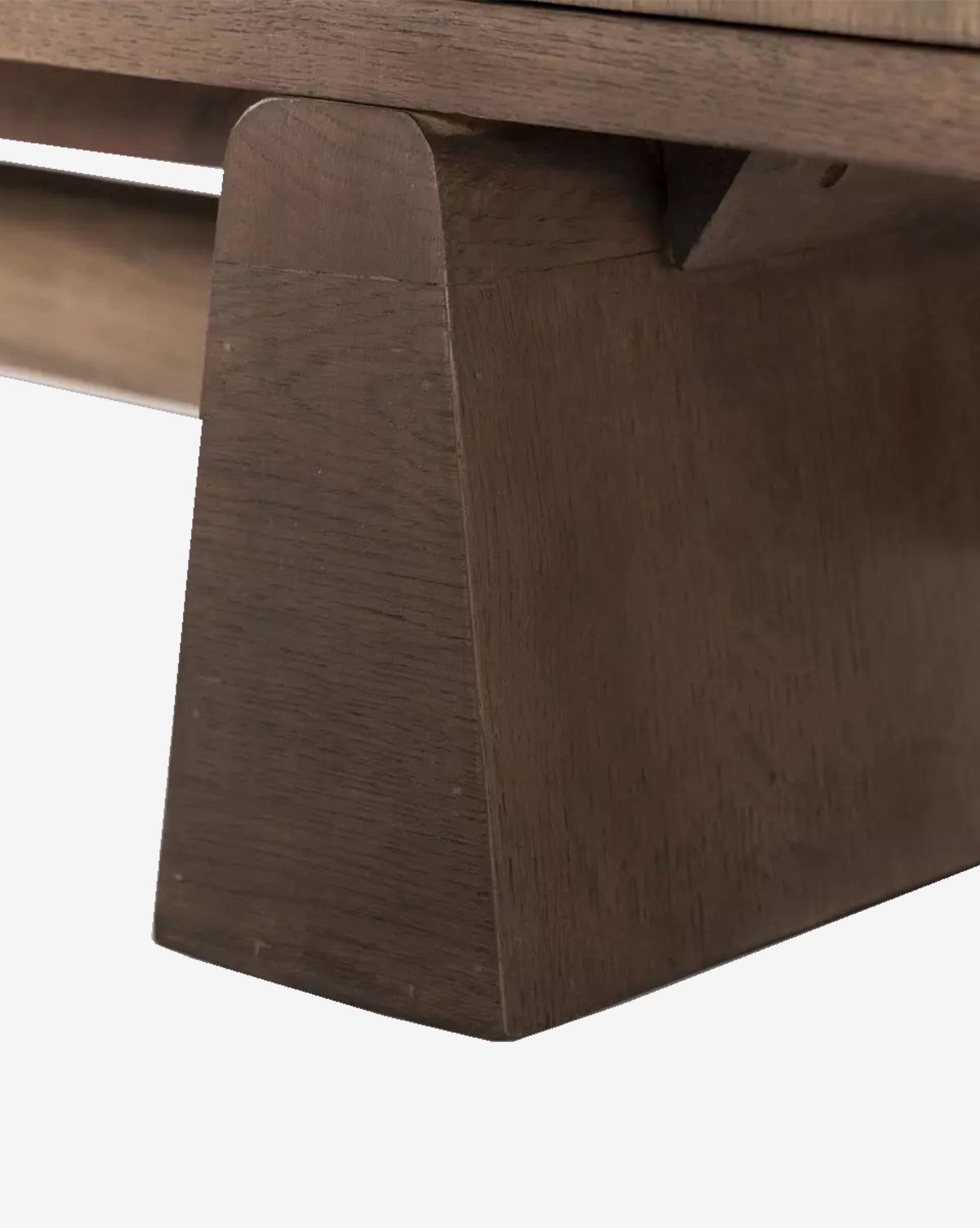 Close-up of the Werner Aged Oak Sideboard’s wooden leg, showcasing its smooth, angled surfaces and natural wood grain in a medium brown finish, by McGee & Co.