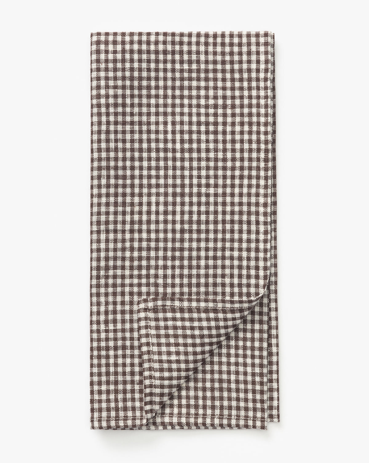 The Westport Linen Tea Towel features a small brown and white gingham check pattern, neatly folded with one corner turned up to display the reverse side, by McGee & Co.