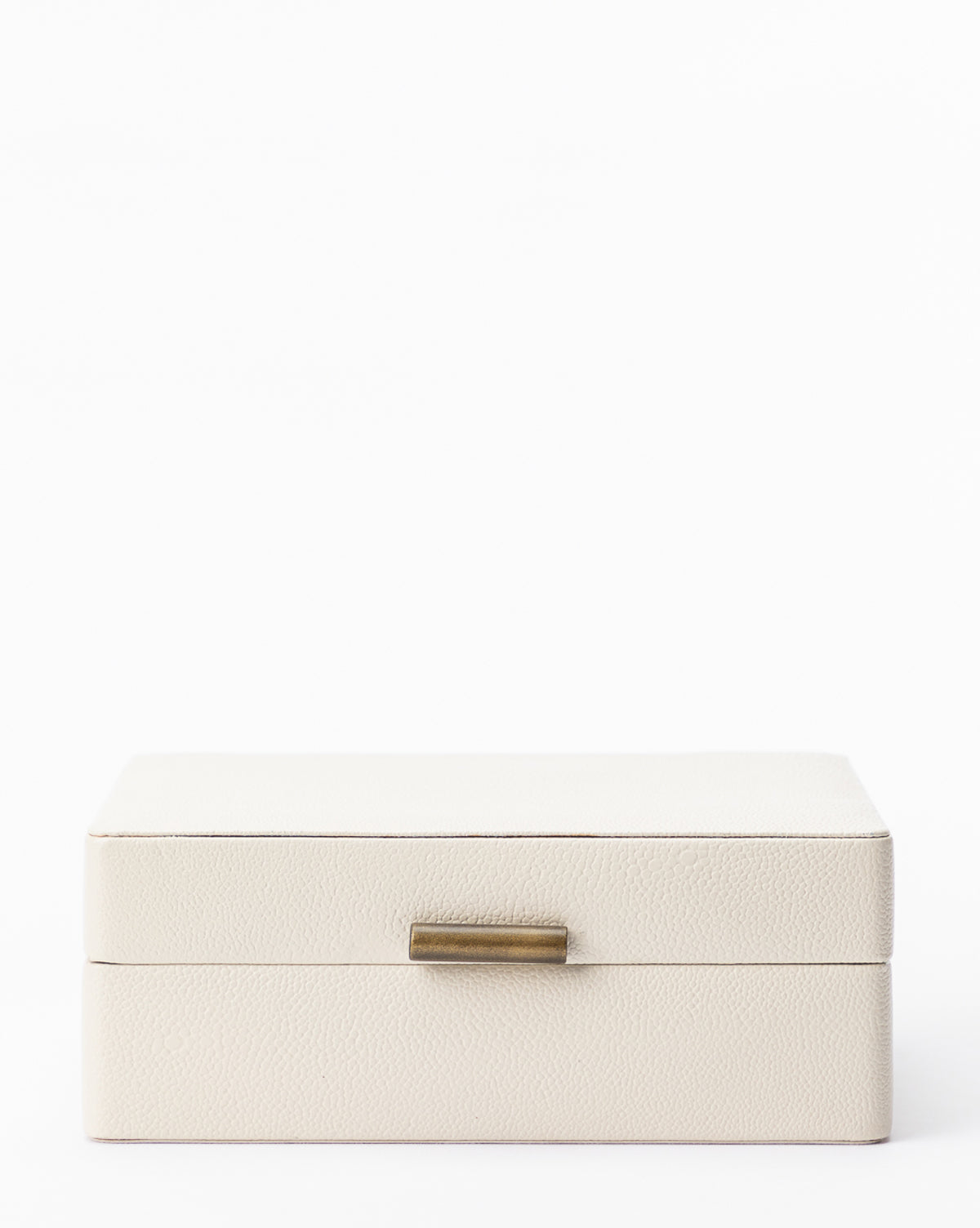 The Cream Shagreen Box is a closed, rectangular decorative storage piece with a textured cream surface and a small gold-colored handle, shown against a plain white background.