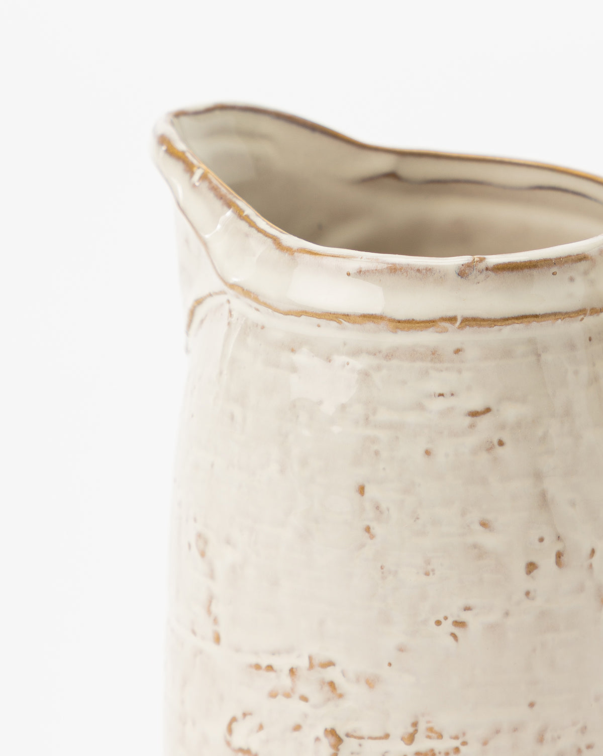Close-up of the White Stoneware Pitcher, handmade with a cream-colored, slightly rough and uneven surface, visible texture details, and an irregular rim, shown against a white background, by McGee & Co.