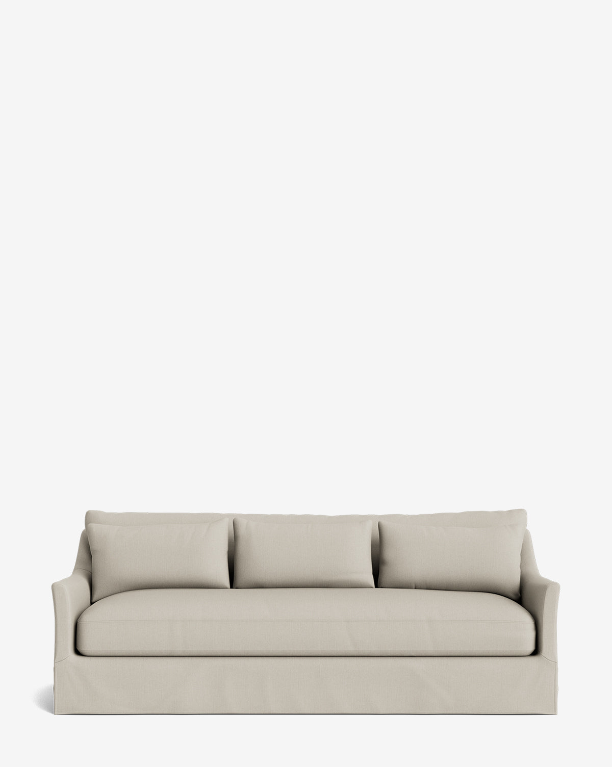 The Wilhelmina Deep Slipcover Sofa (85-110) features a beige upholstered slipcover, three seat cushions, three matching back pillows, slightly flared arms, and a fitted skirt, offering luxurious seating on a plain white background by McGee & Co.