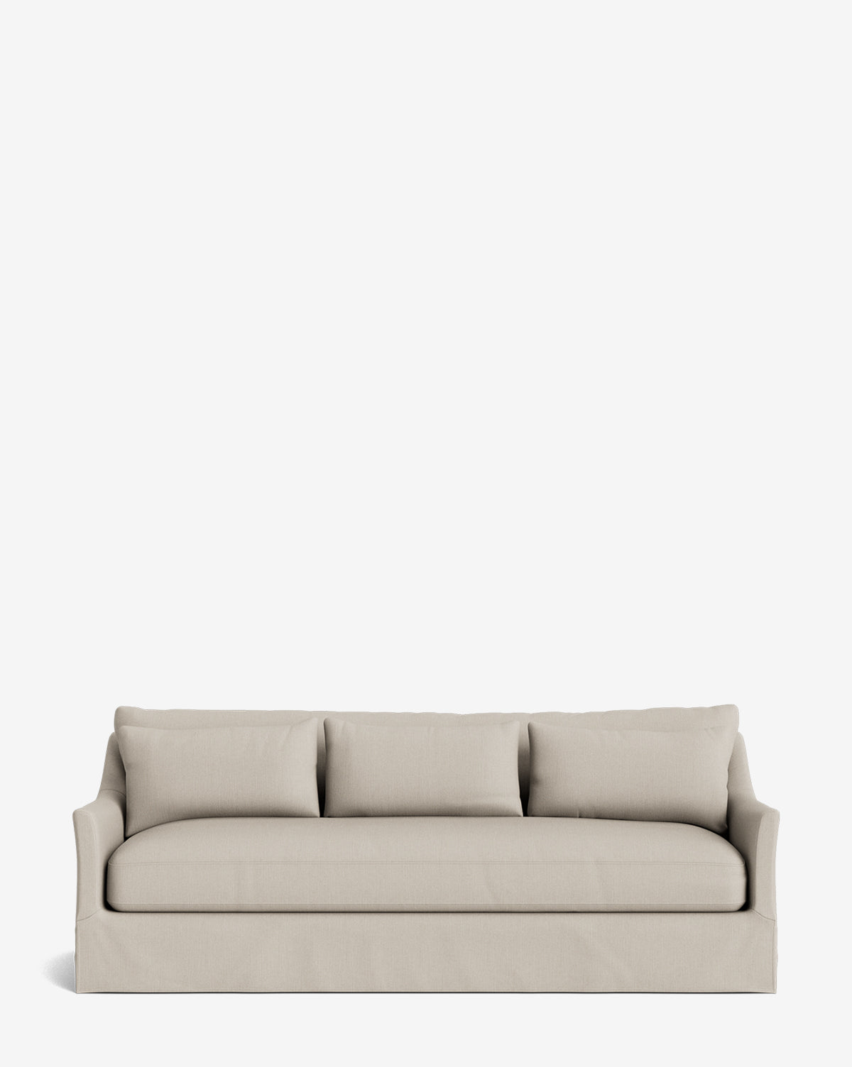 The Wilhelmina Deep Slipcover Sofa (85-110) features a beige slipcover, three seats, three back cushions, and a tailored skirt, offering a luxurious seating option against a plain white background by McGee & Co.