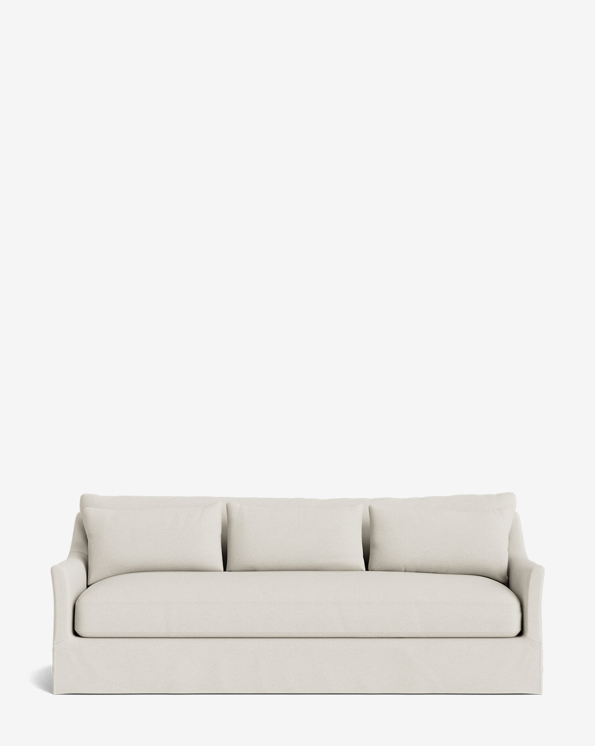 The Wilhelmina Classic Slipcover Sofa (85-110) in light beige features three back cushions, a smooth seat cushion, gently curved arms, and a tailored skirt, displayed against a plain white background by McGee & Co.