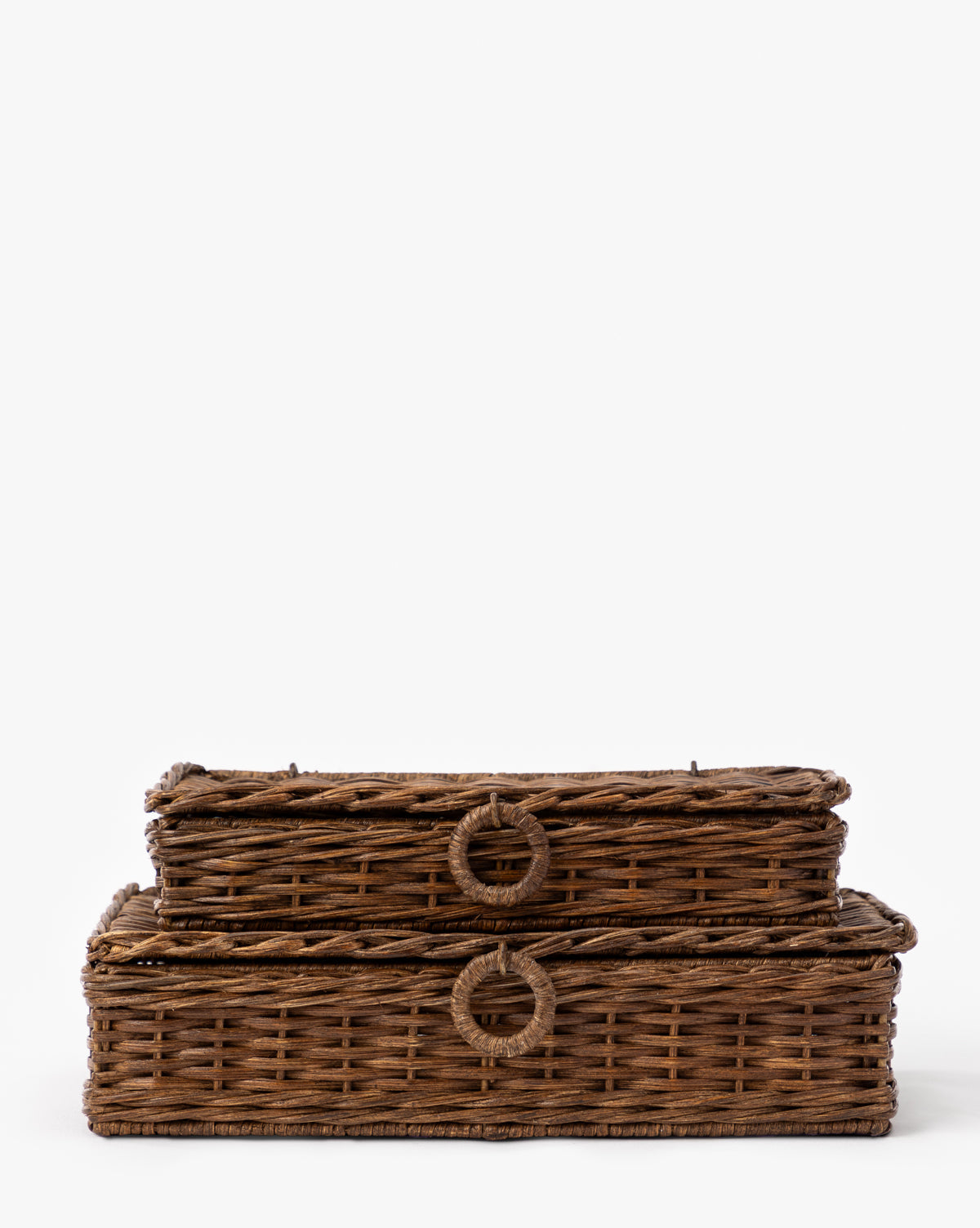Two Windmere Woven Boxes with lids are stacked, each featuring a circular woven handle in front. These rattan boxes add style and function to any space, by McGee & Co. Displayed on a plain white background.
