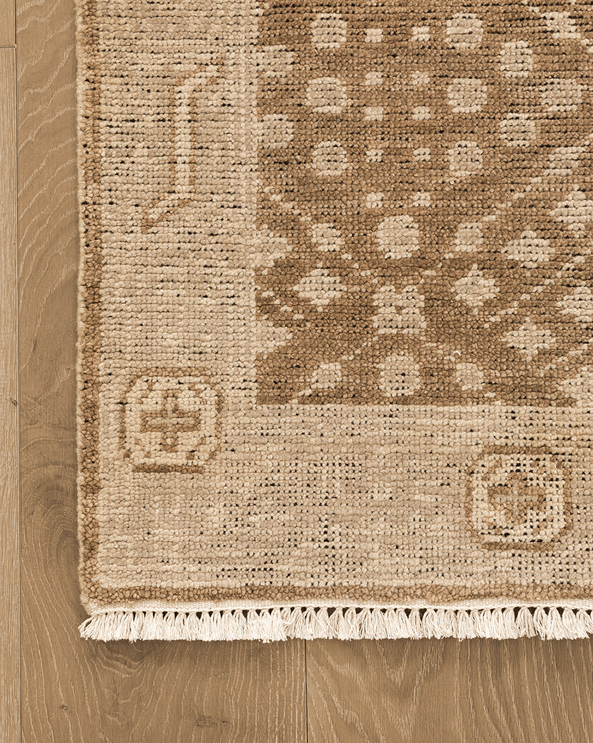This beige wool rug adds timeless elegance to any room, by McGee & Co.