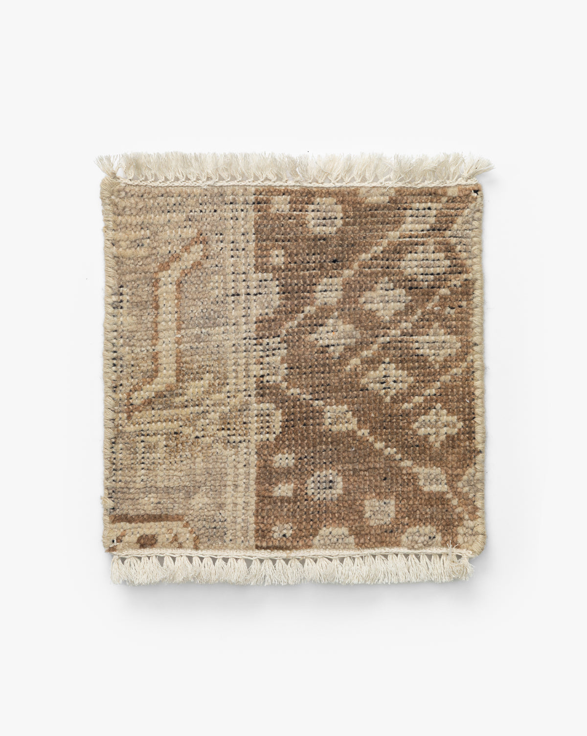 The Windsor Hand-Knotted Wool Rug Swatch is an artisan-crafted, square woven sample with tasseled edges, showcasing a beige and brown patchwork of geometric and abstract patterns, by McGee & Co.