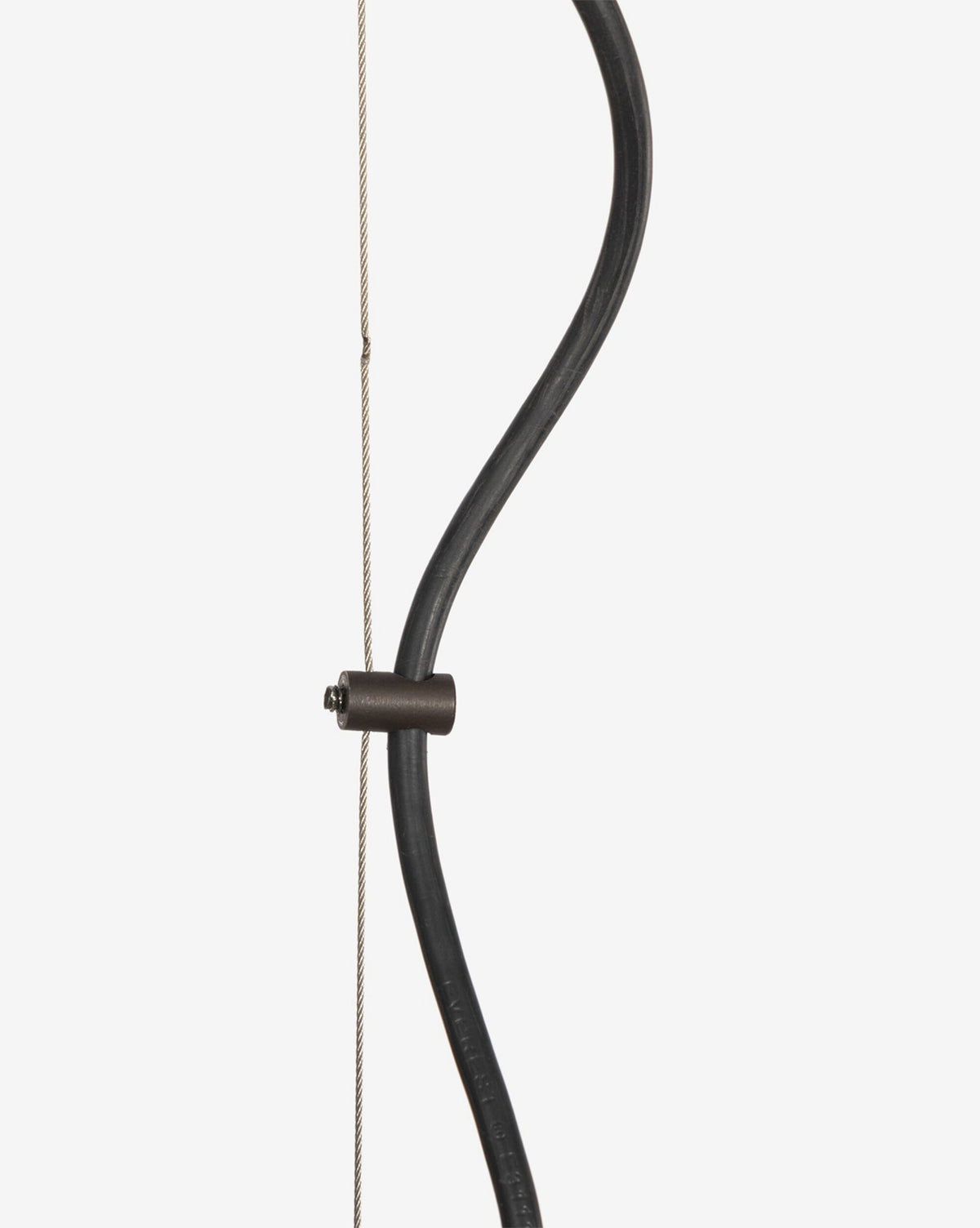 A close-up of a traditional recurve bow with a curved black limb, taut string, and a Winslet Pendant metal fitting connecting the limb to the string against a plain white background, by McGee & Co.