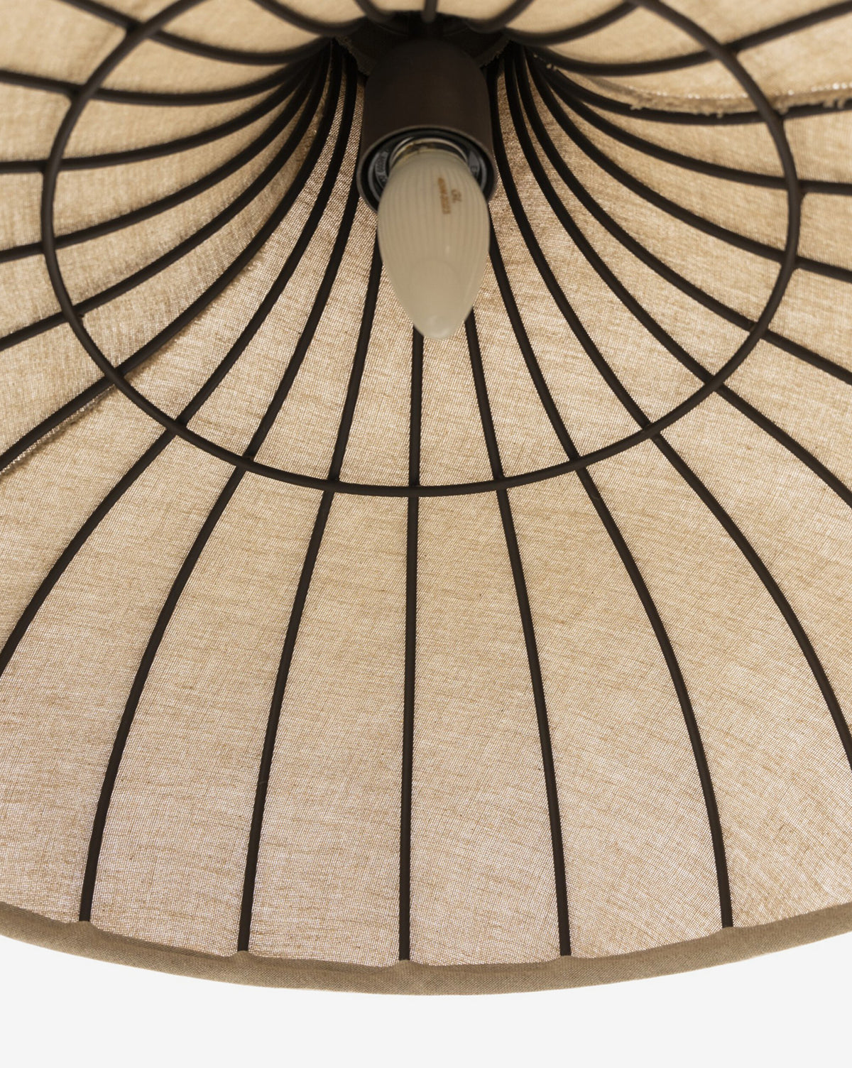 Close-up of the Winslet Pendant’s linen shade underside with black metal ribs and a single centered bulb—a striking detail in modern lighting, by McGee & Co.