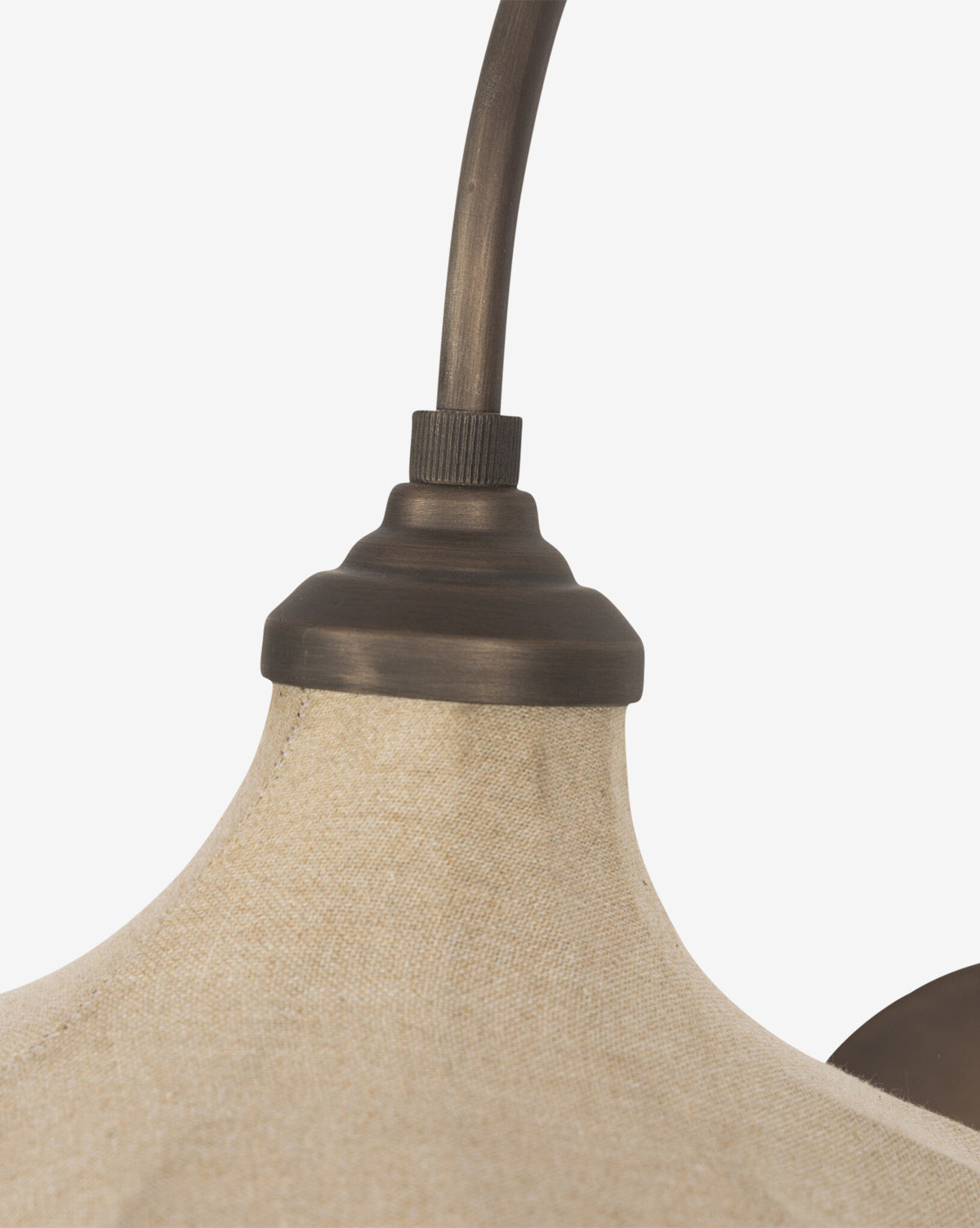 Close-up of the Winslet Sconce's linen lampshade with a textured beige surface and a dark bronze fixture connecting to its curved arm, shown against a plain white background, by McGee & Co.