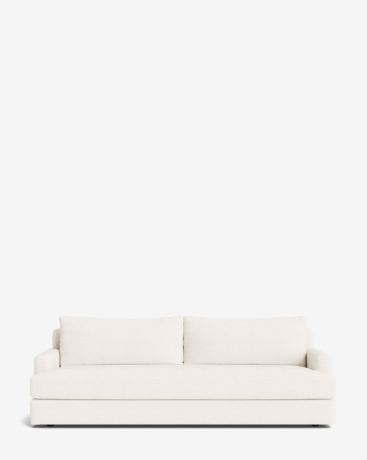The Winthrop Sofa 90 is a modern, minimalist made-to-order sofa in off-white, featuring two large back cushions and low arms, shown against a plain white background by McGee & Co.