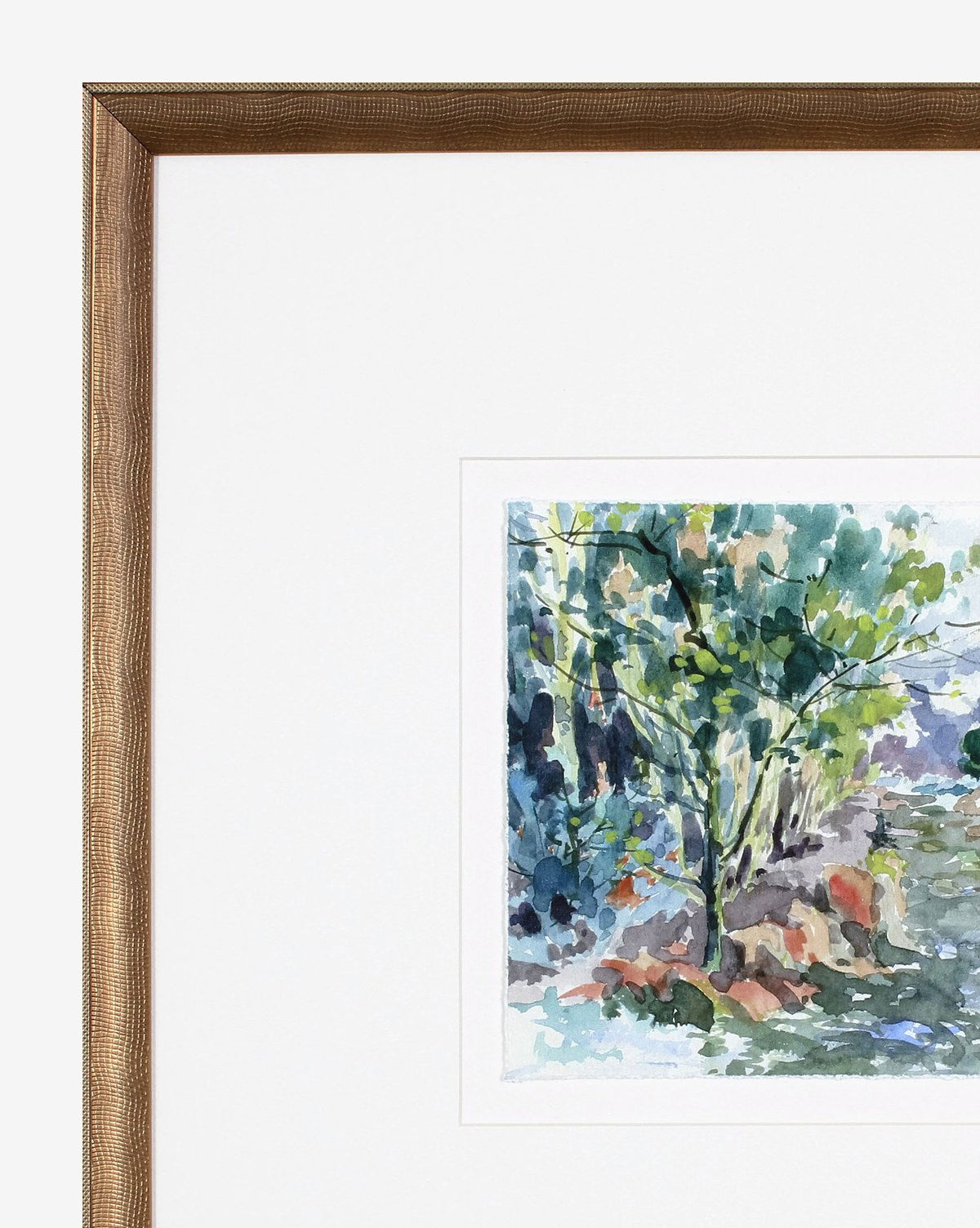 The framed “Woodnote 1” watercolor features a lush green tree amid vibrant foliage and a winding path, all set in a textured wooden frame—an ideal addition to any gallery wall.