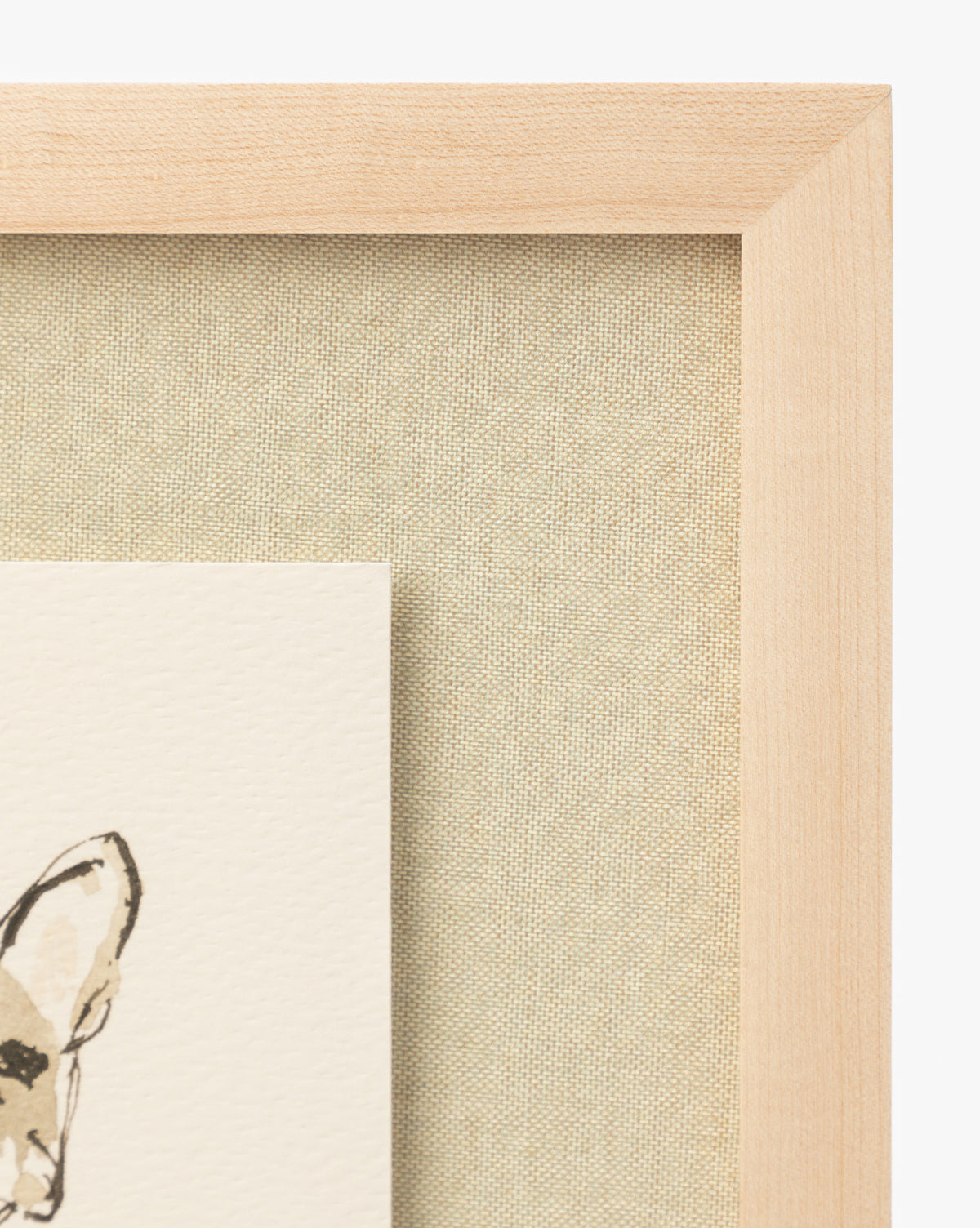 Close-up of a wooden picture frame with a beige mat; the lower left shows part of an animals ear from the Woof print—ideal as fine art for children’s rooms or framed wall art, by McGee & Co.