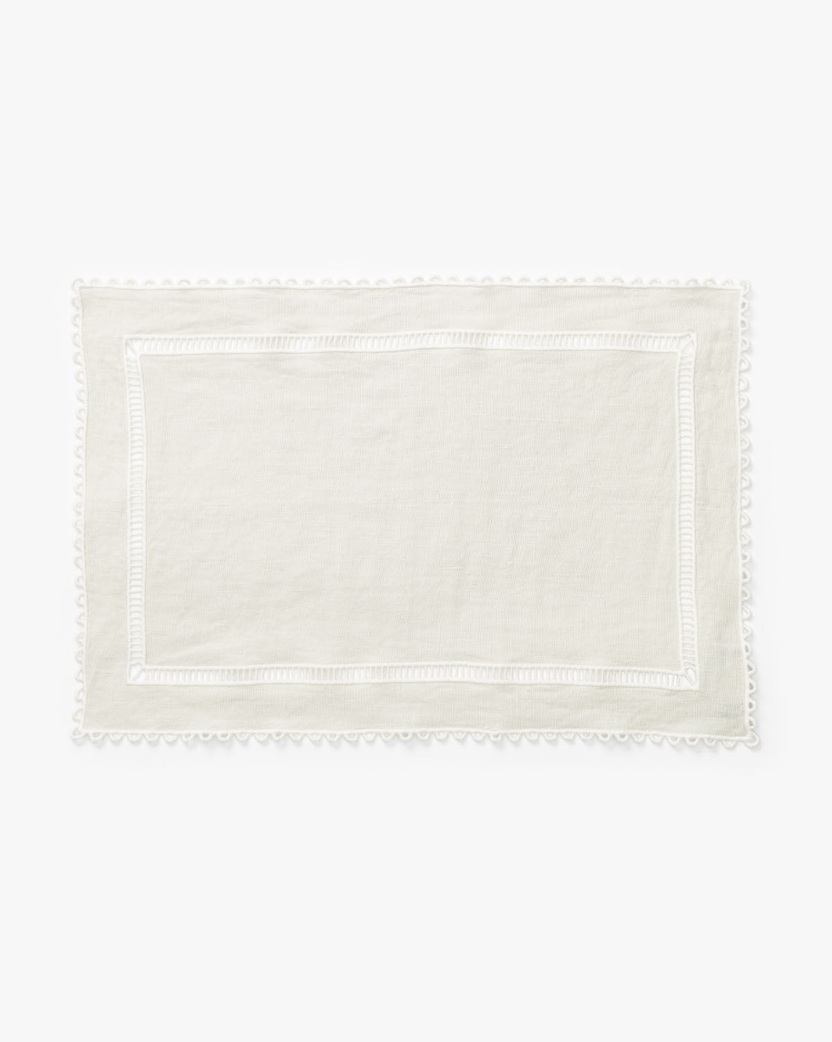 The Woven Rectangle Placemat is a rectangular, off-white linen placemat with a subtle border and delicate lace trim—ideal for enhancing any dining table setting, by McGee & Co.