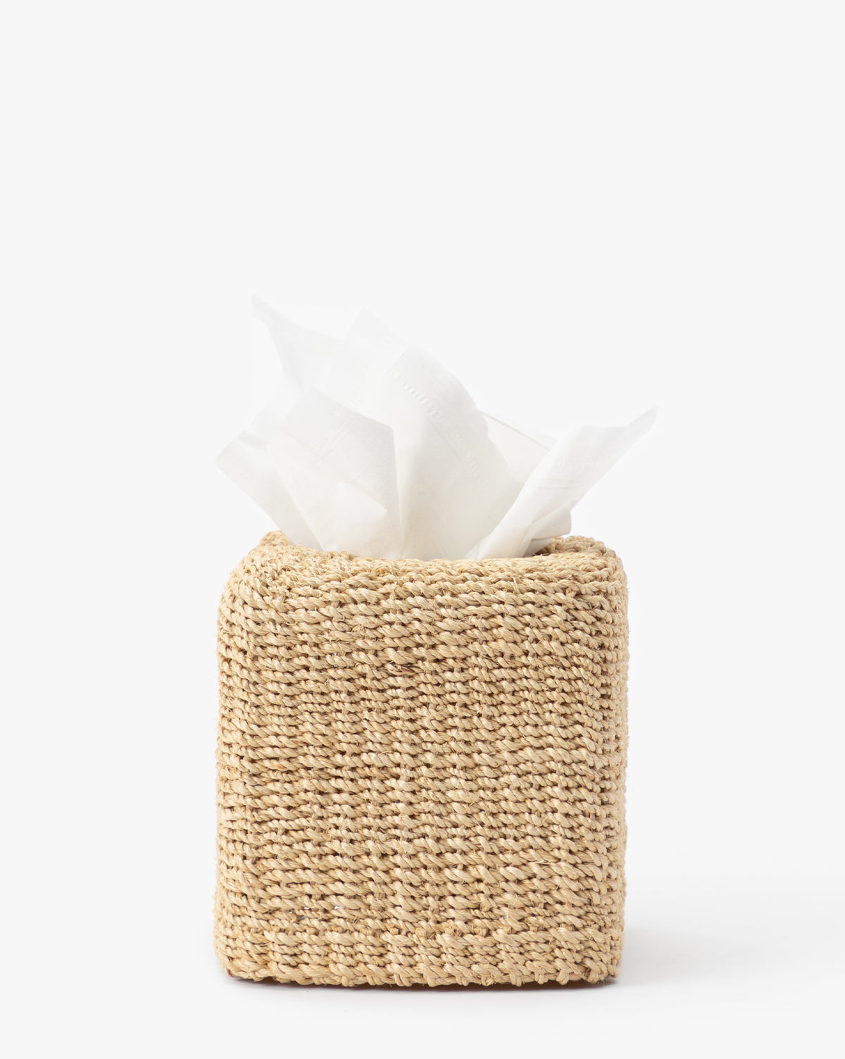 The Woven Tissue Box Cover, crafted from abaca fiber, features a square design with white tissues visible—an elegant addition to your bathroom decor.