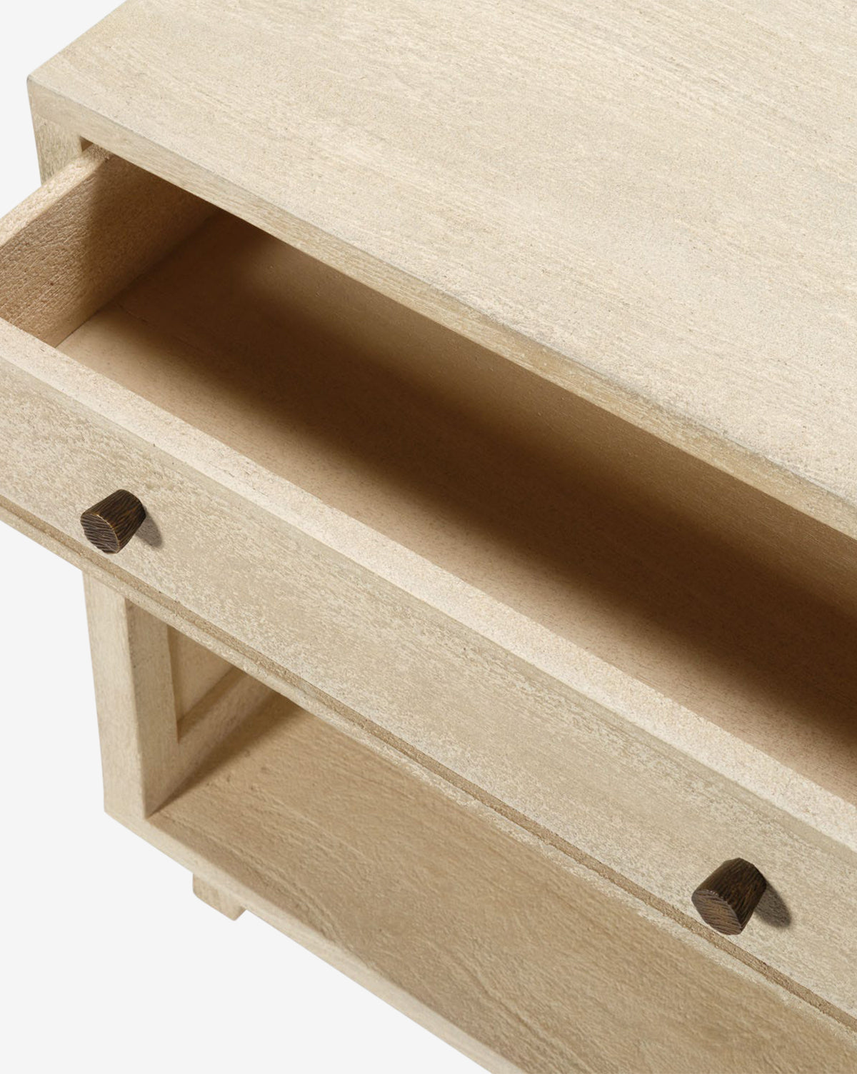 A close-up of the Wrenna Nightstand shows its light wood finish, one drawer partially open with an empty interior, and two square wooden knobs—ideal for adding a modern touch to any bedroom, by McGee & Co.
