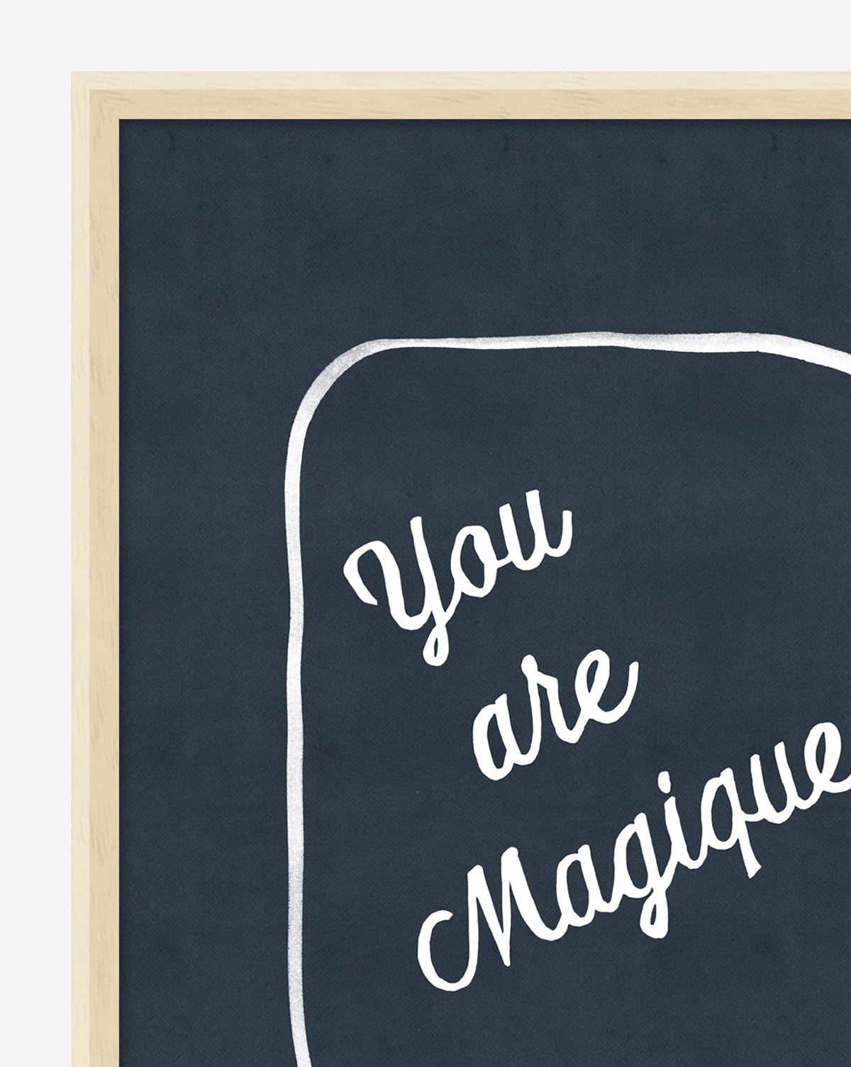 The You are Magique chalkboard-style black board features a light wood frame and displays the handwritten affirmation You are Magique in white cursive, surrounded by a loosely drawn rectangular border.