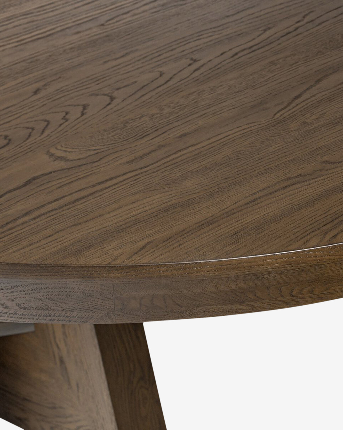 Close-up of the Yvonne Dining Table, highlighting its smooth dark finish and distinctive oak woodgrain, set against a plain white background by McGee & Co.