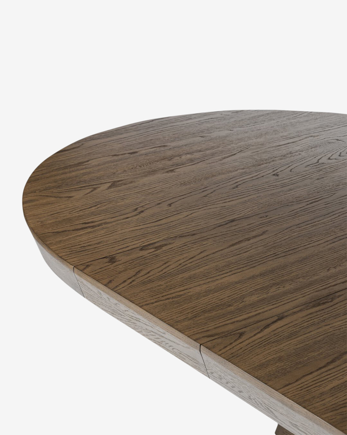 Close-up of the Yvonne Dining Table with smooth, rounded edges and visible oak grain, showcasing its natural texture. The dark finish contrasts sharply against the plain white background, by McGee & Co.