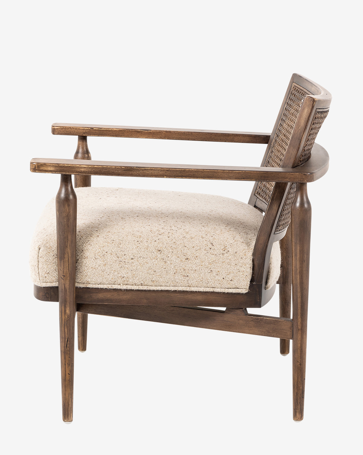 Side view of the Zalan Lounge Chair, showcasing a woven cane back, light beige Belgian linen seat cushion, angled legs, and curved armrests in a mid-century modern design, by McGee & Co.