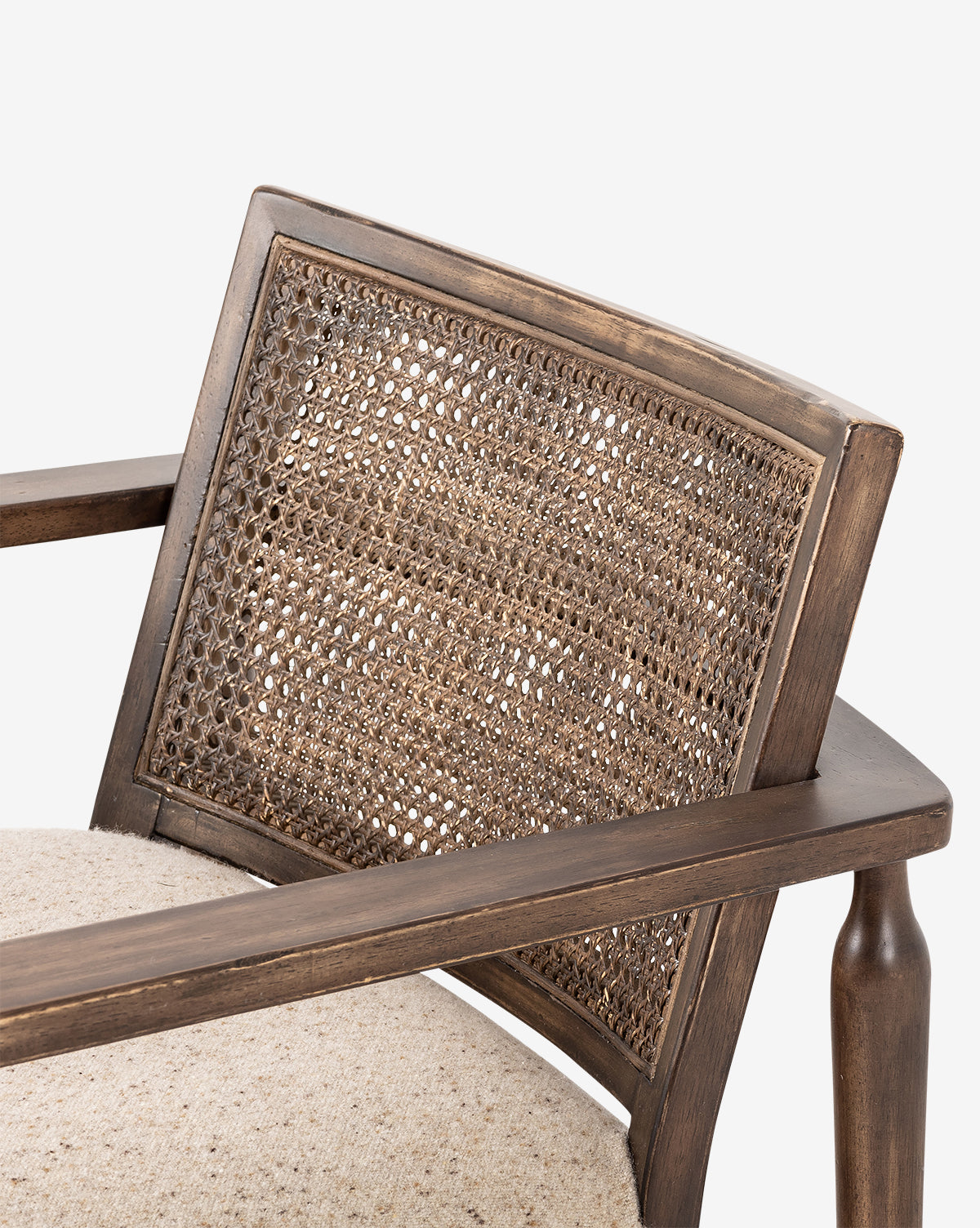 Close-up of the Zalan Lounge Chair featuring a woven cane backrest, detailed armrest, and light beige Belgian linen seat that highlights the texture of its materials, by McGee & Co.