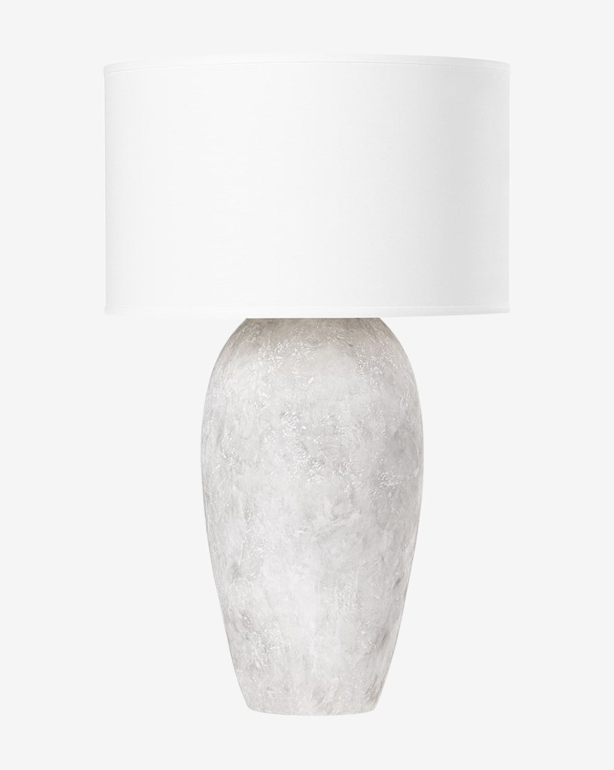 The Zeke Table Lamp showcases a textured, oval white ceramic base with a weathered gray finish and a large cylindrical white shade, set against a plain white background by McGee & Co.