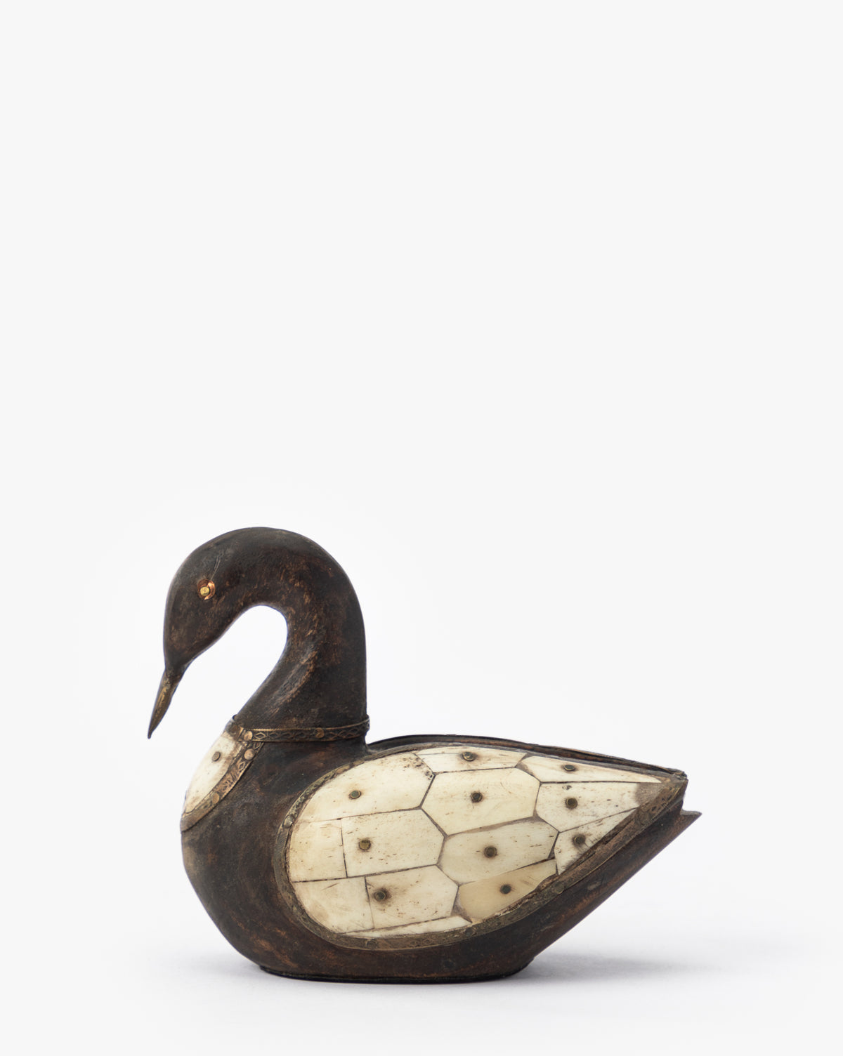 The Zella Swan Object is a carved, dark-toned swan figurine featuring vintage-inspired ivory bone inlay panels on its body and chest, displayed against a simple white background.