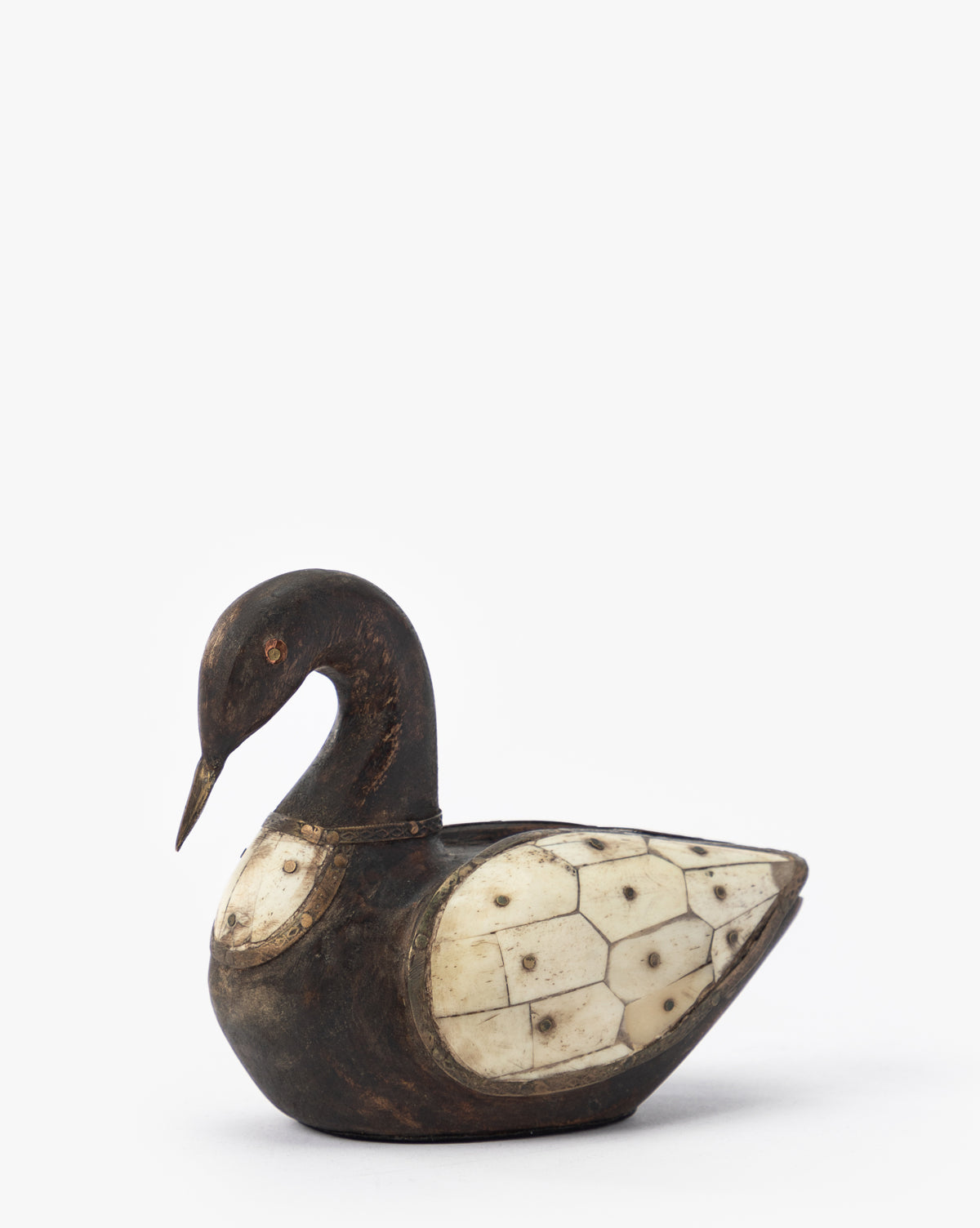 The Zella Swan Object is a carved wooden swan figurine with a dark finish and vintage-inspired bone inlay on its wings, shown against a plain white background.