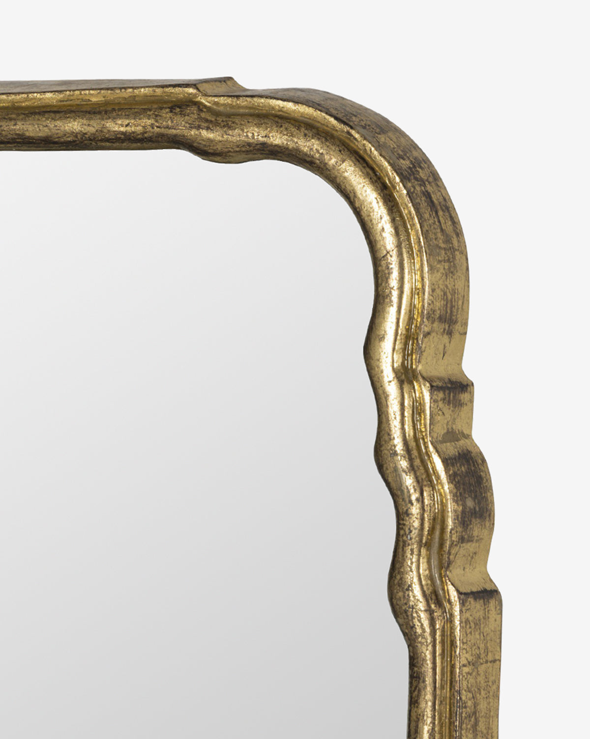 Close-up of the Zosia Wall Mirror’s top corner, showcasing its ornate, antique-style gold frame against a plain white background—perfect for adding elegant charm to your home decor, by McGee & Co.