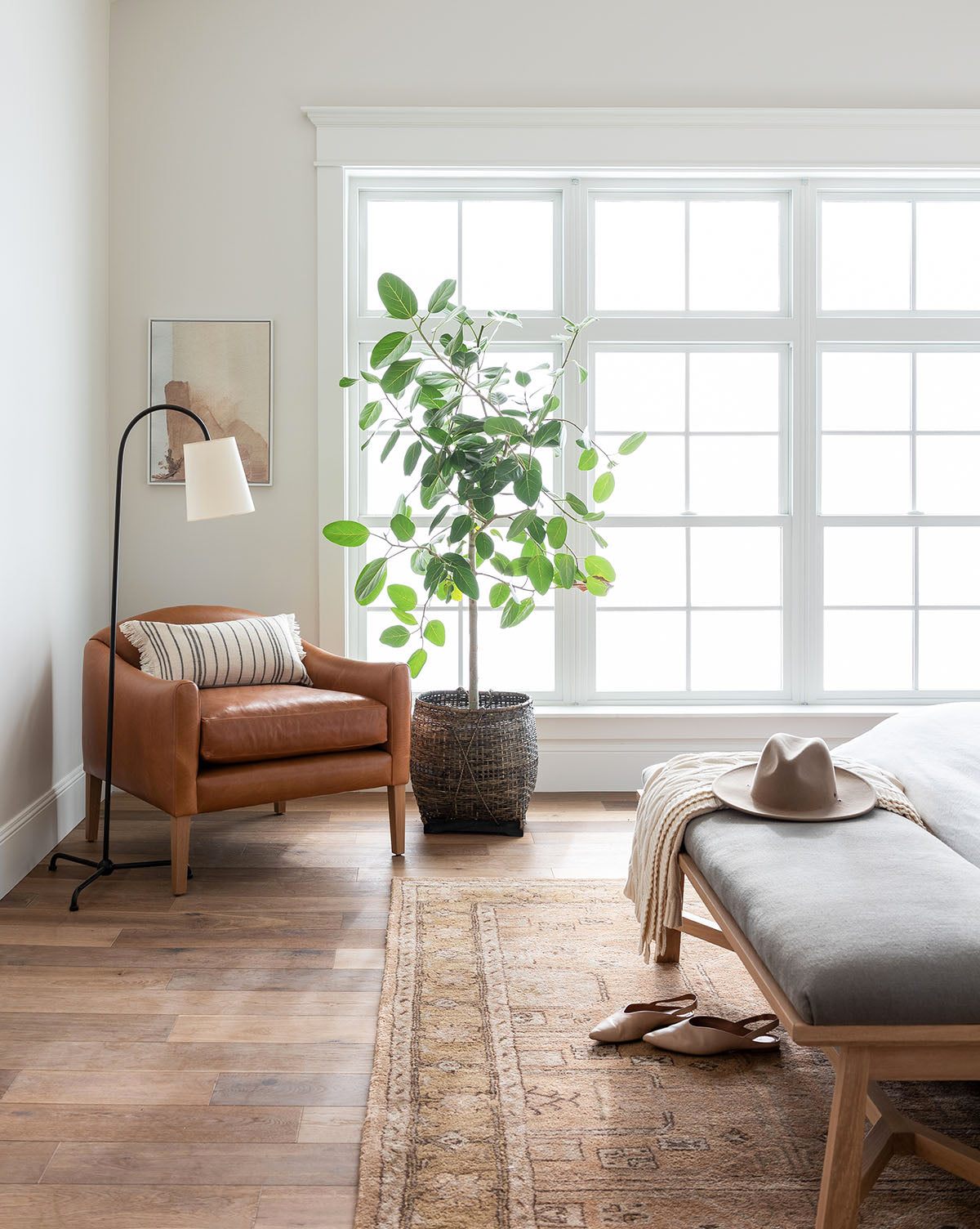 Light wood floors and the Ellington Fawn Hand-Tufted Wool Rug add warmth, by McGee & Co.