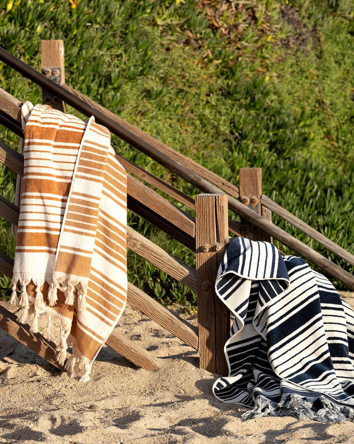 Large beach towels shown in camel and navy stripes from McGee & Co.
