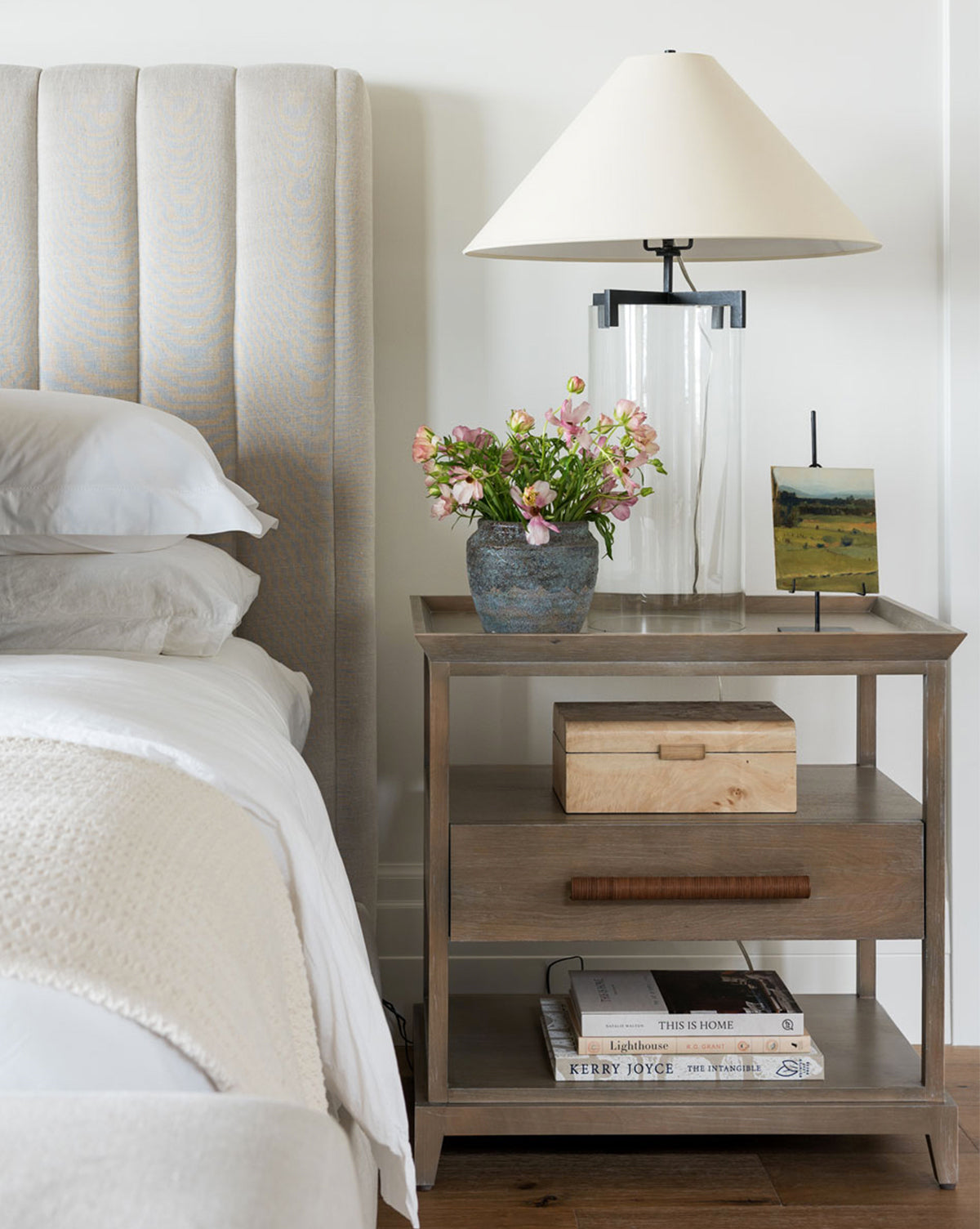 Nightstand view of earthy textured pot with flowers from McGee & Co.