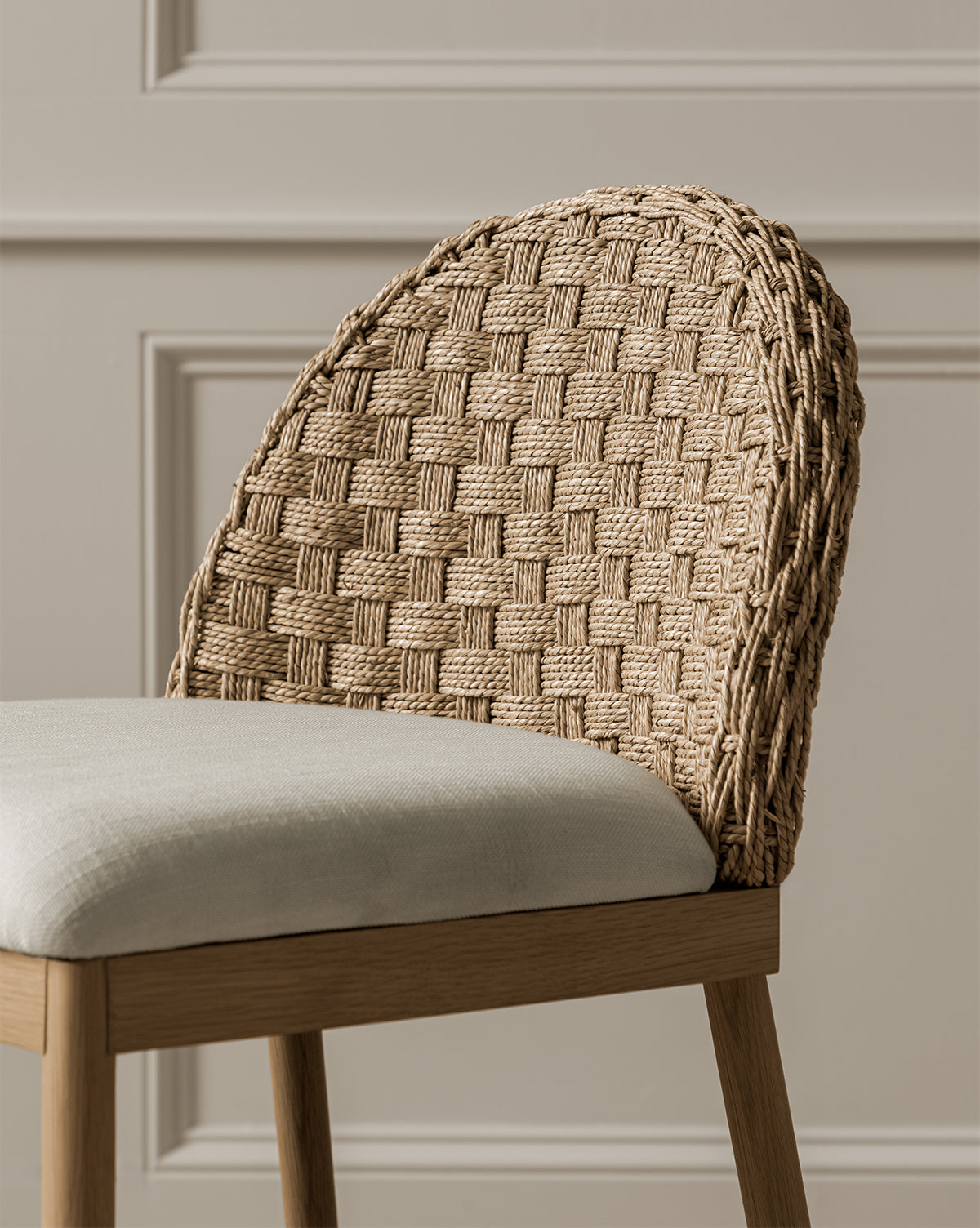 Close up of Molly chair rattan backseat and white cushion with a solid oak frame from McGee & Co.