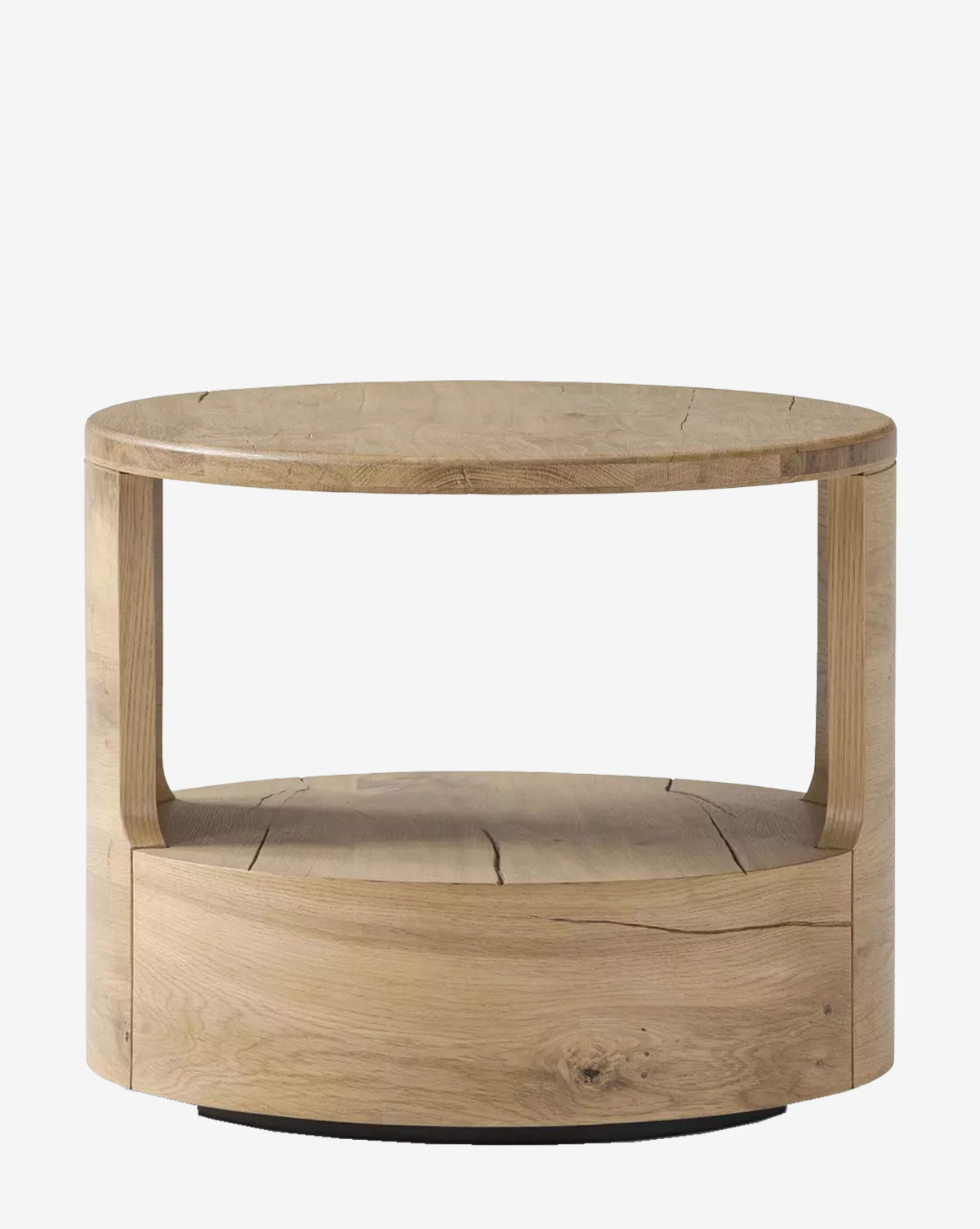 The Adams End Table by Four Hands is a round piece crafted from reclaimed French Oak, featuring an open shelf beneath the tabletop and a natural finish that highlights the wood grain—a stylish, contemporary accent for any space. McGee & Co.